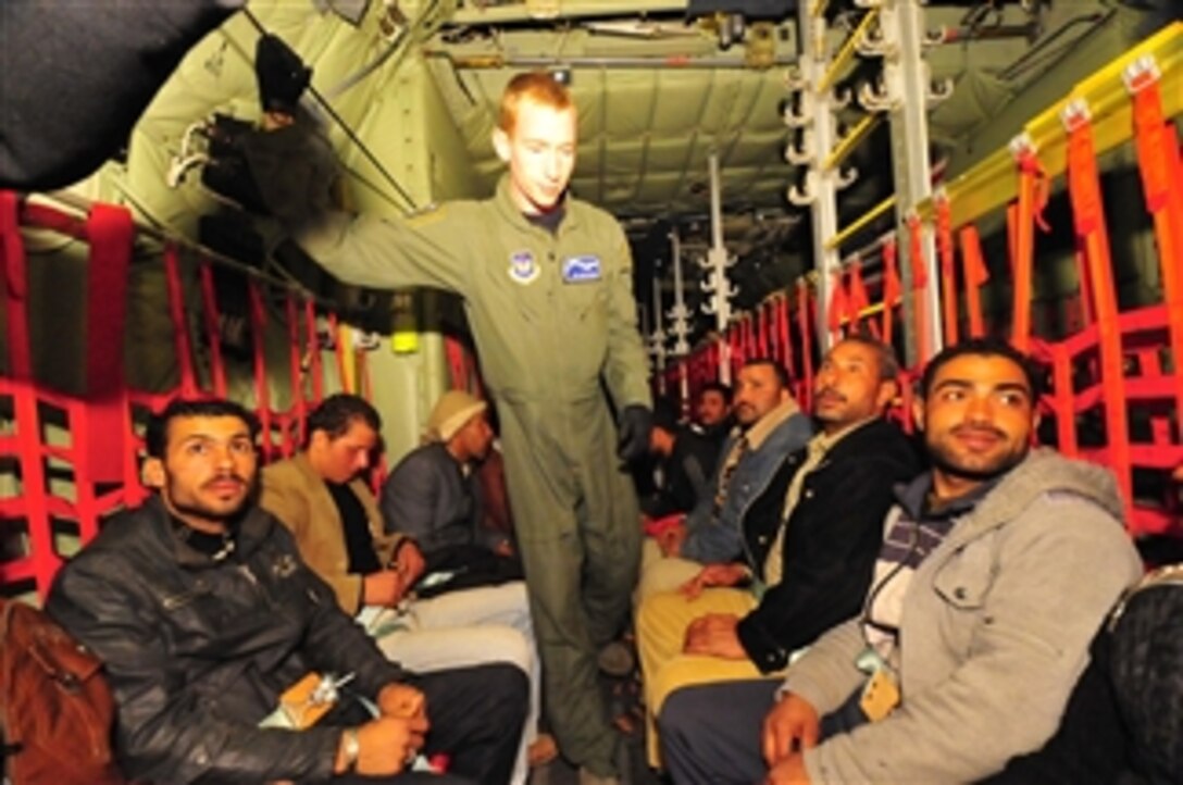Egyptian refugees travel aboard a U.S. Air Force C-130J Super Hercules aircraft en route to Cairo, Egypt, after fleeing from Libya and Tunisia on March 5, 2011.  This response to the developing humanitarian crisis was part of an international effort to repatriate tens of thousands of refugees fleeing the violence in Libya.  