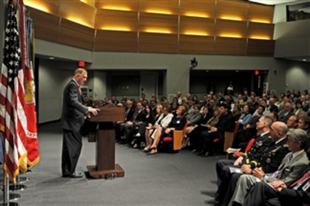 Deputy Secretary of Defense William J. Lynn III hosts a change of directorship ceremony in the Pentagon auditorium for the Joint Improvised Explosive Device Defeat Organization on March 4, 2011.  Seated in the front row are Secretary of the Army John McHugh (right), the newly appointed incoming organization director Army Lt. Gen. Michael D. Barbero and outgoing director Army Lt. Gen. Michael L. Oaes (3rd from right).  