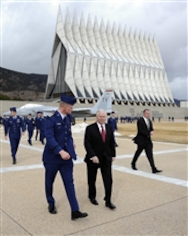 Secretary of Defense Robert M. Gates walks with U.S. Air Force Academy Cadet Wing Commander Josh Larson prior to teaching both a Political Science and National Security class as part of the Capstone Seminar at the Air Force Academy in Colorado Springs, Co., on March 4, 2011.  