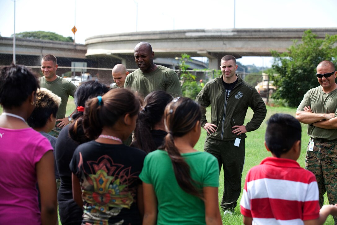 (Center) Staff Sgt. Michael A. Johnson, company gunnery sergeant for Headquarters Company, Headquarters and Service Battalion, U. S. Marine Corps Forces, Pacific, introduces a group of Marine volunteers to Aiea Elementary School students March 8 at the school, here.::r::::n::MarForPac Marines assisted the school’s physical education teacher with her classes as part of the command’s ongoing community service efforts. MarForPac officials plan to continue volunteering at numerous schools around the community.