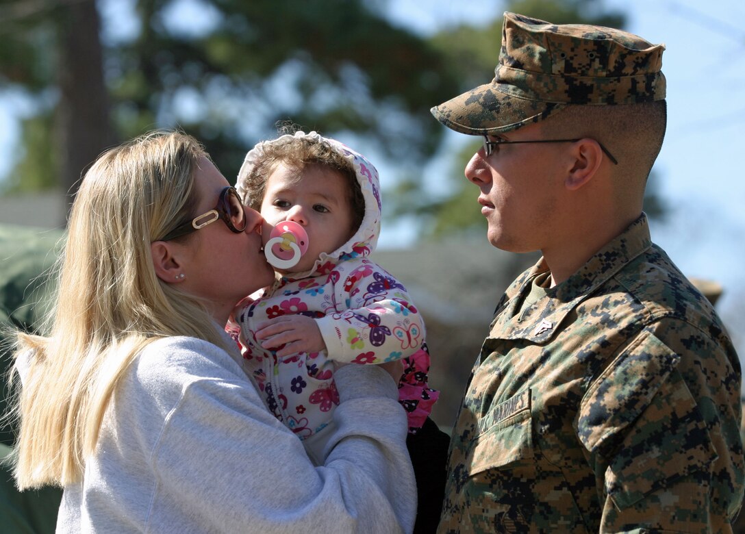 Corporal Joshua Villada, the assistant chief of Guns Platoon, Romeo Battery, 5th Battalion, 10th Marine Regiment, 2nd Marine Division, says good bye to his family aboard Marine Corps Base Camp Lejeune N.C., March 8, 2011, before his six-month deployment to Okinawa, Japan.  Villada will be participating in a series of exercises while on deployment.