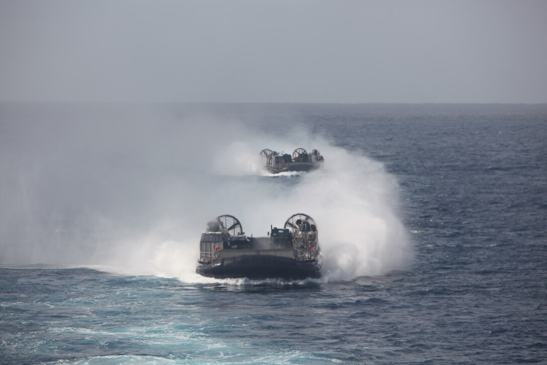 Two U.S. Navy landing craft air cushioned, carrying vehicles and equipment of Combat Logistics Battalion 31, 31st Marine Expeditionary Unit, operate at sea from the USS Harpers Ferry (LSD 49), March 8.  Elements of the 31st MEU are embarked aboard the USS Harpers Ferry (LSD 49) for the MEU’s scheduled patrol of the Asia-Pacific region, enhancing theater security and conducting bilateral training with multiple partner nations.  The 31st MEU is the U.S.’s only continually forward-deployed MEU, and remains a force-in-readiness in the Asia-Pacific region at all times.