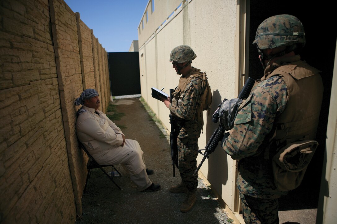 Marines with Military Police Company, Combat Logistics Regiment 37, 3rd Marine Logistics Group, III Marine Expeditionary Force, interview an actor playing the role of an Afghan farmer who was present at a tactical site and suspected of bomb making during the forensic material  collection and exploitation course in the Central Training Area March 8. The training teaches Marines how to process personnel found at tactical sites along with processing the sites for biometric data.