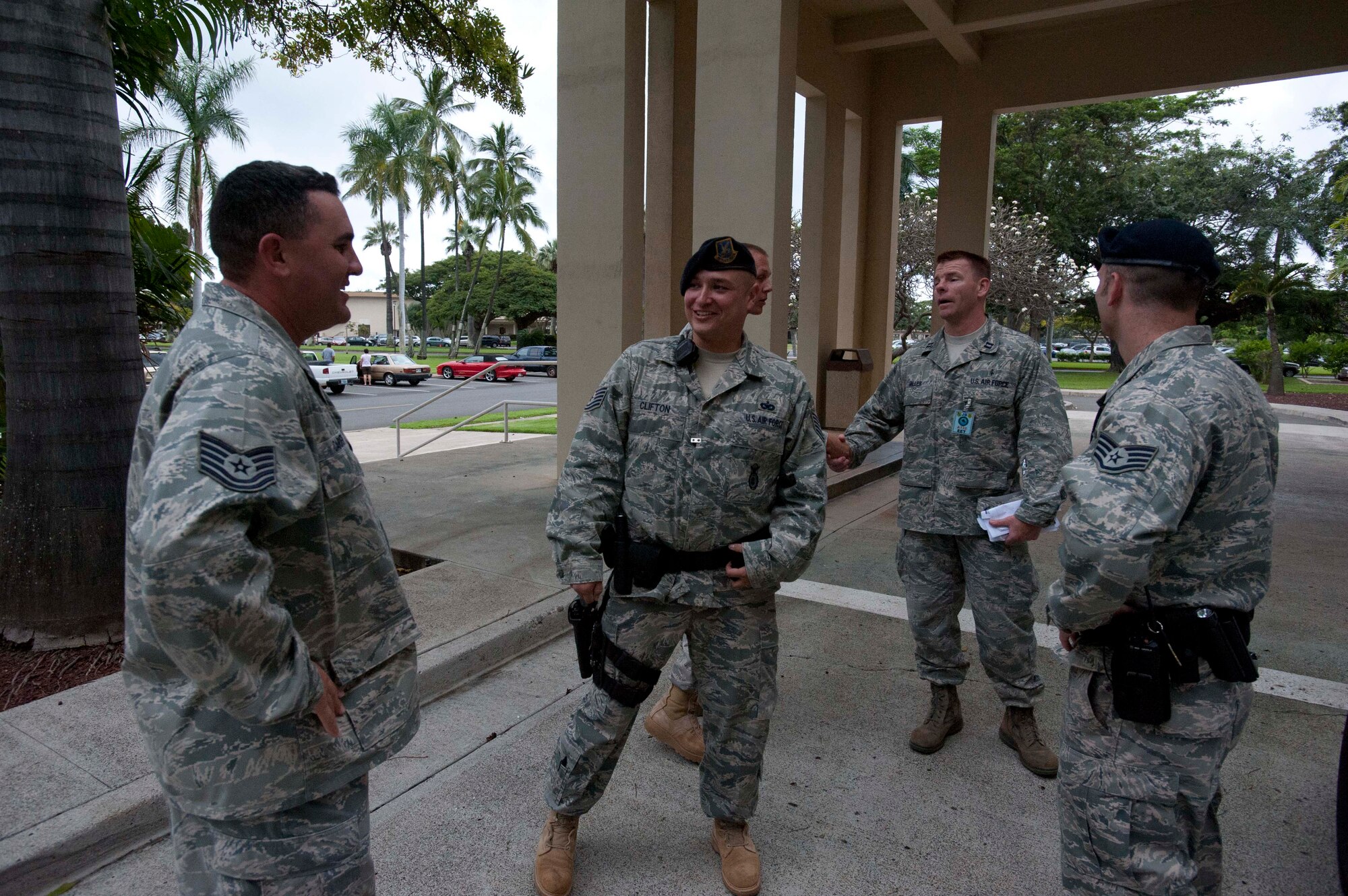 Security Forces release Tech. Sgt. Casey Carden, 15th Operations Group intel analyst (center), after "arresting" him as he plays the role of an unruly, irate customer at the pharmacy during a portion of the 15th Wing's Operational Readiness Exercise Mar. 3 at Joint Base Pearl Harbor Hickam, Hawaii. The ORE different elements of the 15th Wing's capabilities such as the ability of Airmen to respond to injected scenarios, deploy quickly, and survive and operate in a deployed environment. (U.S. Air Force photo/Staff Sgt. Nathan Allen)