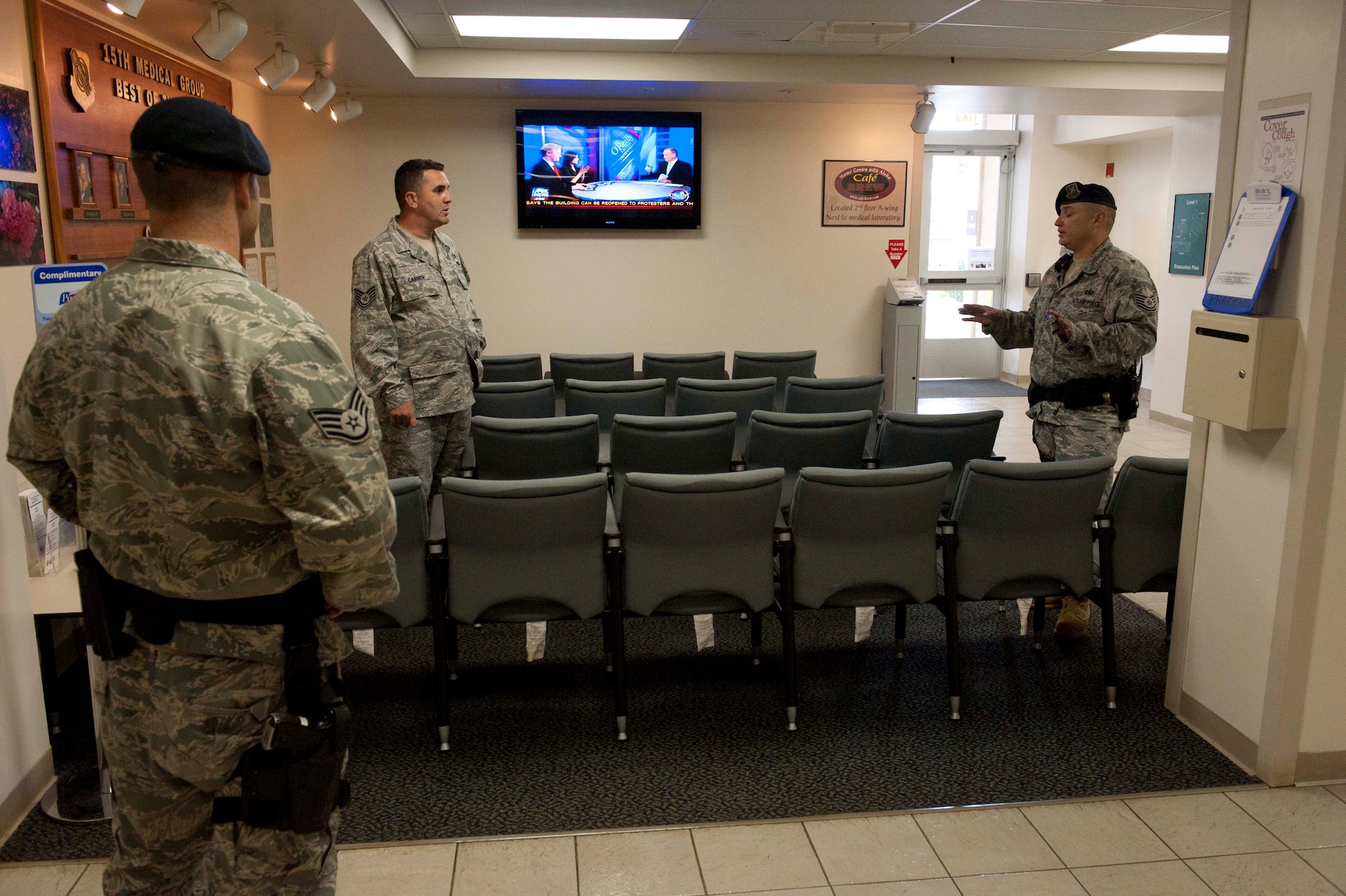 Security Forces personnel prepare to arrest Tech. Sgt. Casey Carden, 15th Operations Group intel analyst (center), as he plays the role of an unruly, irate customer at the pharmacy during a portion of the 15th Wing's Operational Readiness Exercise Mar. 3 at Joint Base Pearl Harbor Hickam, Hawaii. The ORE different elements of the 15th Wing's capabilities such as the ability of Airmen to respond to injected scenarios, deploy quickly, and survive and operate in a deployed environment. (U.S. Air Force photo/Staff Sgt. Nathan Allen)