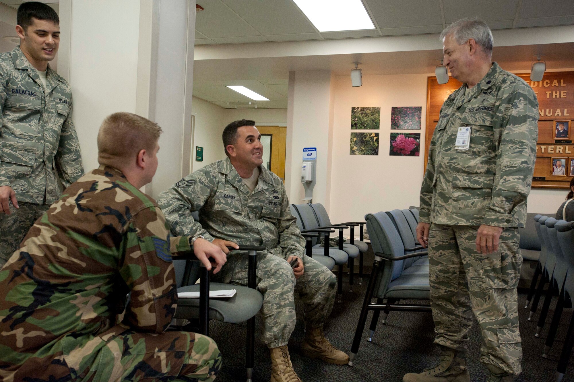 Medical personnel from the 15th Medical Group try to calm down Tech. Sgt. Casey Carden, 15th Operations Group intel analyst (center), as he plays the role of an unruly, irate customer at the pharmacy during a portion of the 15th Wing's Operational Readiness Exercise Mar. 3 at Joint Base Pearl Harbor Hickam, Hawaii. The ORE different elements of the 15th Wing's capabilities such as the ability of Airmen to respond to injected scenarios, deploy quickly, and survive and operate in a deployed environment. (U.S. Air Force photo/Staff Sgt. Nathan Allen)