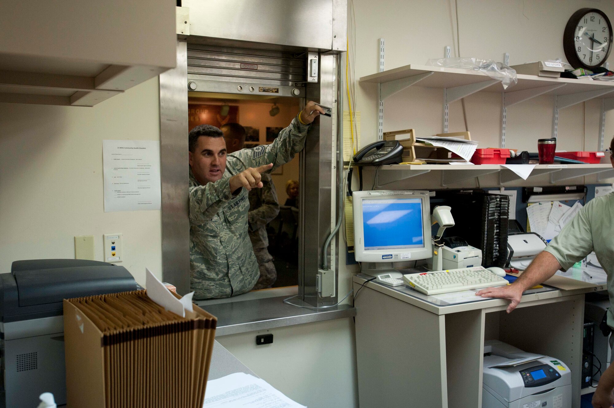 Tech. Sgt. Casey Carden, 15th Operations Group intel analyst, plays the role of an unruly, irate customer at the pharmacy during a portion of the 15th Wing's Operational Readiness Exercise Mar. 3 at Joint Base Pearl Harbor Hickam, Hawaii. The ORE different elements of the 15th Wing's capabilities such as the ability of Airmen to respond to injected scenarios, deploy quickly, and survive and operate in a deployed environment. (U.S. Air Force photo/Staff Sgt. Nathan Allen)