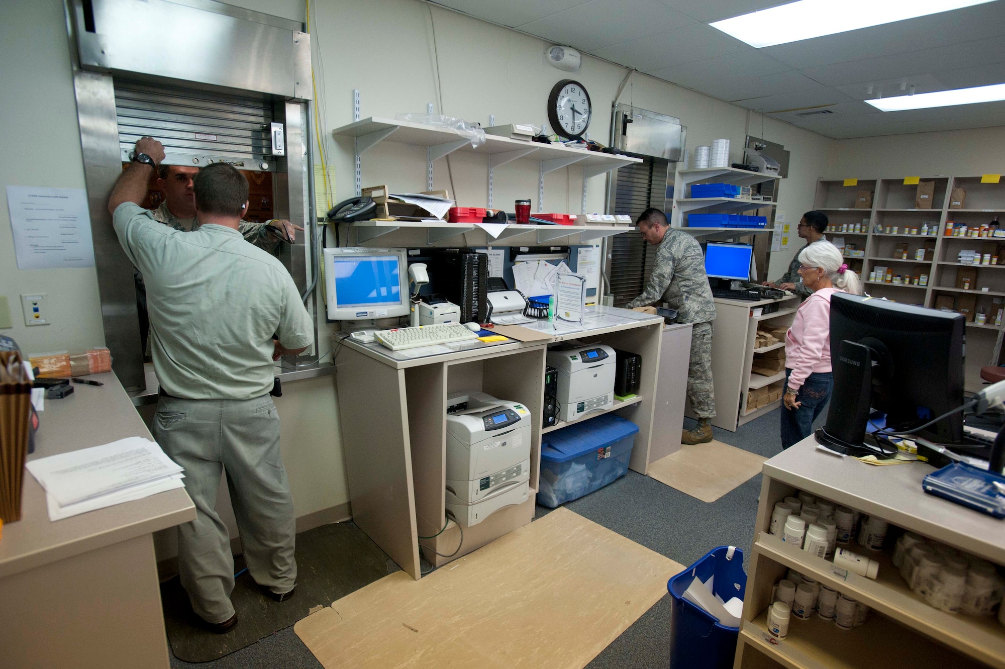 Pharmacy workers take precautions to limit pharmacy access due to an unruly, irate customer during a portion of the 15th Wing's Operational Readiness Exercise Mar. 3 at Joint Base Pearl Harbor Hickam, Hawaii. The ORE different elements of the 15th Wing's capabilies such as the ability of Airmen to respond to injected scenarios, deploy quickly, and survive and operate in a deployed environment.
(U.S. Air Force photo/Staff Sgt. Nathan Allen)