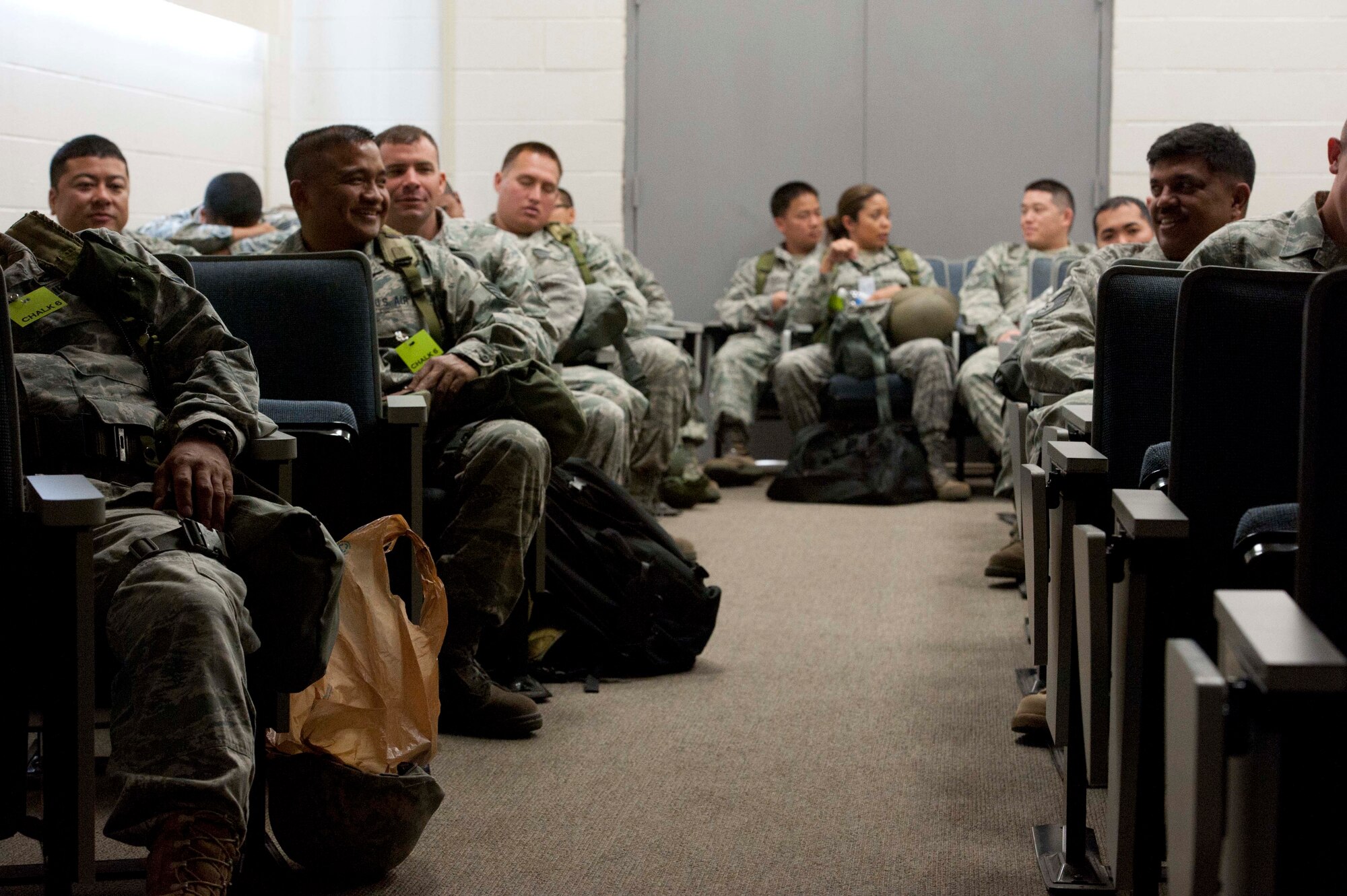 Reservists await a briefing in preparation to "deploy" during a portion of the 15th Wing's Operational Readiness Exercise Mar. 3 at Joint Base Pearl Harbor Hickam, Hawaii. The ORE different elements of the 15th Wing's capabilities such as the ability of Airmen to respond to injected scenarios, deploy quickly, and survive and operate in a deployed environment. (U.S. Air Force photo/Staff Sgt. Nathan Allen)