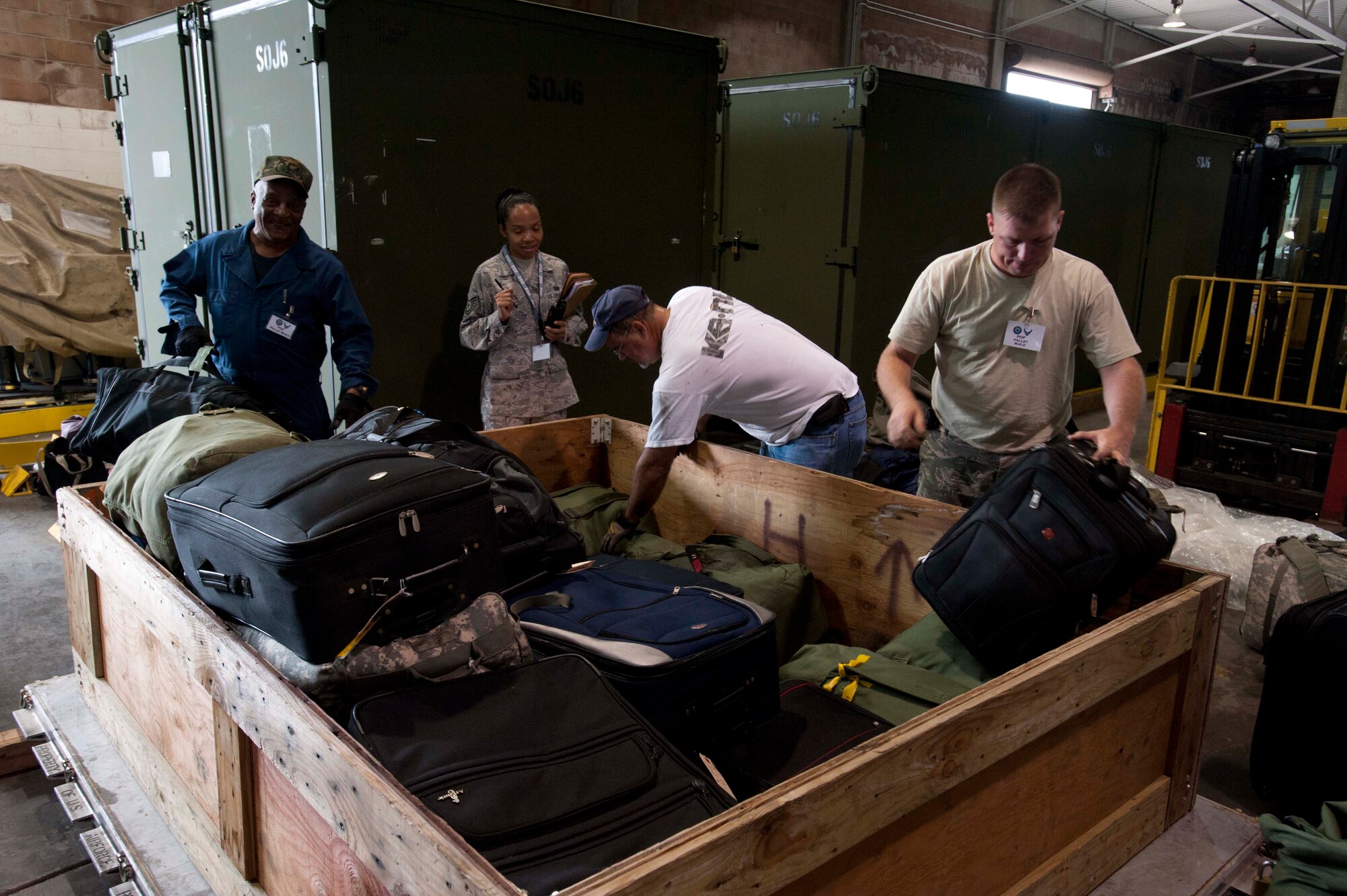 Members of the pallet build team build a pallet from personal bags given by reservists preparing to "deploy" during a portion of the 15th Wing's Operational Readiness Exercise Mar. 3 at Joint Base Pearl Harbor Hickam, Hawaii. The ORE different elements of the 15th Wing's capabilities such as the ability of Airmen to respond to injected scenarios, deploy quickly, and survive and operate in a deployed environment. (U.S. Air Force photo/Staff Sgt. Nathan Allen)