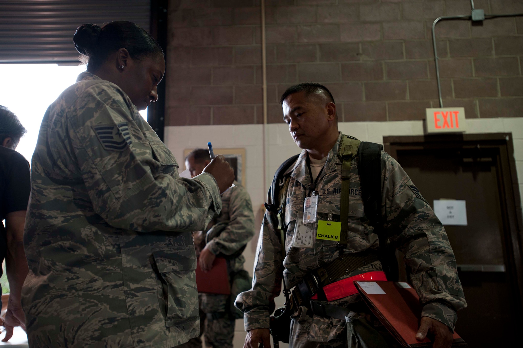Members of the 647th Force Support Squadron help reservists preparing to "deploy" during a portion of the 15th Wing's Operational Readiness Exercise Mar. 3 at Joint Base Pearl Harbor Hickam, Hawaii. The ORE different elements of the 15th Wing's capabilities such as the ability of Airmen to respond to injected scenarios, deploy quickly, and survive and operate in a deployed environment. (U.S. Air Force photo/Staff Sgt. Nathan Allen)