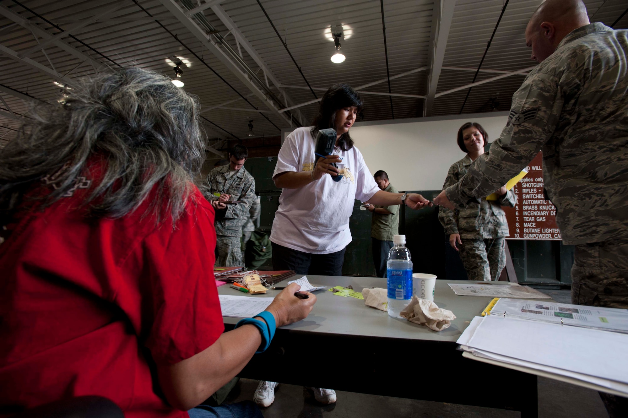 Members of the 647th Force Support Squadron help reservists preparing to "deploy" during a portion of the 15th Wing's Operational Readiness Exercise Mar. 3 at Joint Base Pearl Harbor Hickam, Hawaii. The ORE different elements of the 15th Wing's capabilities such as the ability of Airmen to respond to injected scenarios, deploy quickly, and survive and operate in a deployed environment. (U.S. Air Force photo/Staff Sgt. Nathan Allen)
