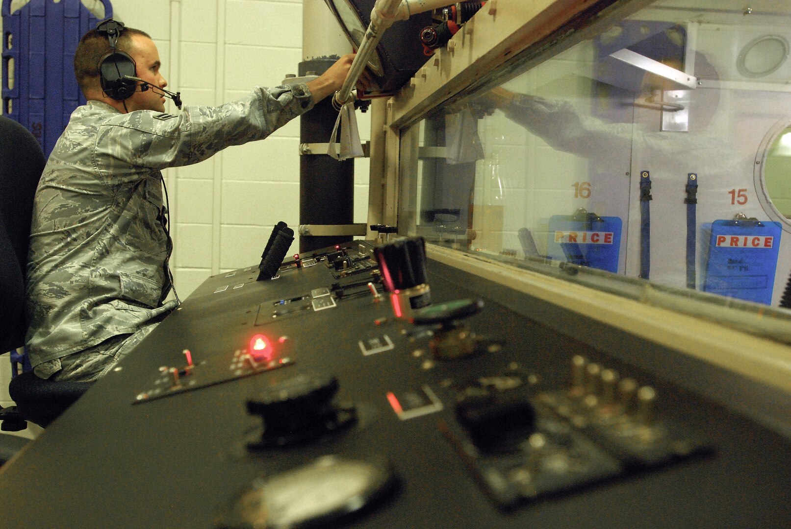 Airman 1st Class Joseph Kennedy, 359th Aeromedical Squadron, performs preflight checks while at the controls of the hypobaric chamber used for altitude training and testing of aircrew and pilots, Randolph Air Force Base, Texas. (U. S. Air Force photo/Brian McGloin)