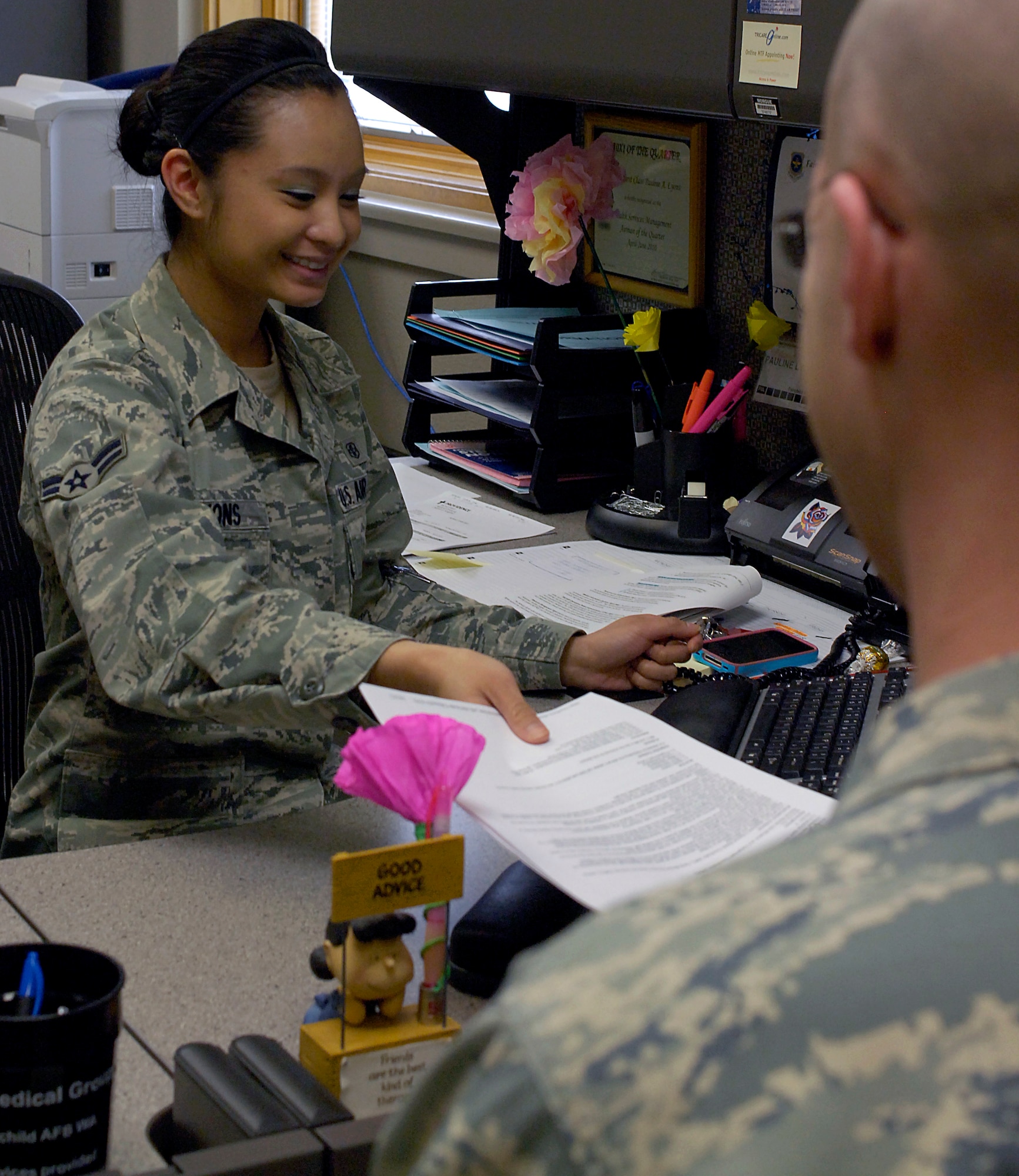 Airman 1st Class Pauline Lyons collects a patient’s paperwork Feb. 8, 2011 at the clinic here. Airman Lyons works in beneficiary services as a patient administrator for the 92nd Medical Group. As a patient administrator, she files medical records for Airman deploying and, in and out-processing from the base. She also gives briefings on what is available at the clinic here.  (U.S. Air Force photo/ Senior Airman Natasha E. Stannard)