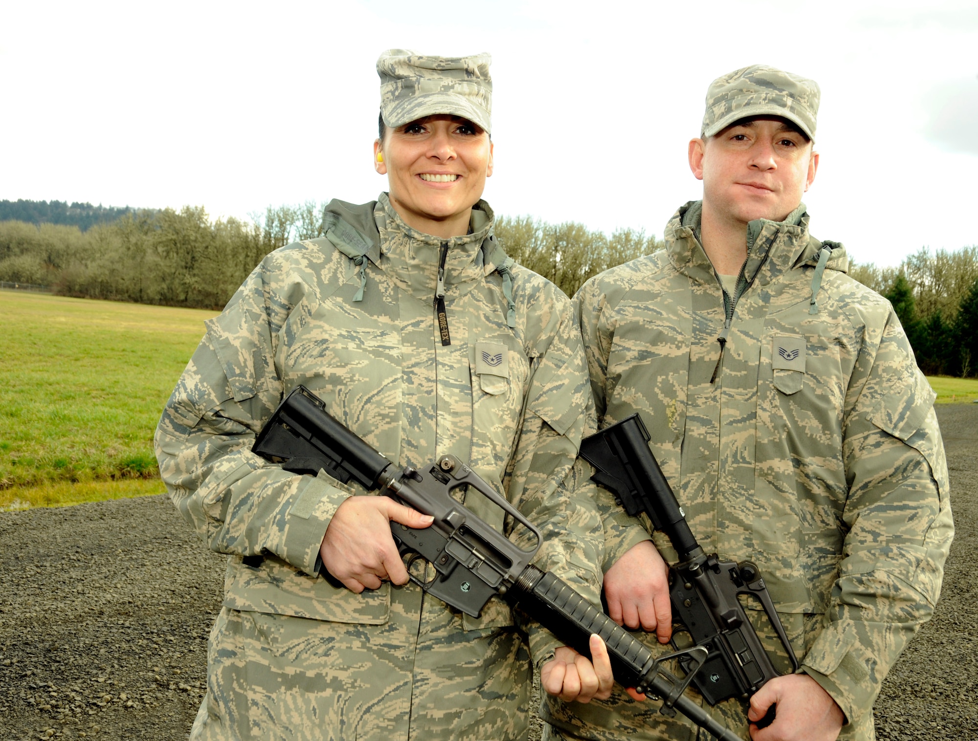 Oregon Air National Guard Tech. Sgt. Michelle Lowe and Staff Sgt. Richard Lowe, of the 116th Air Control Squadron prepare to qualify with their weapons at Camp Adair, Ore., on February 17, 2011. The married Airmen plan to deploy together to the Middle East in March of 2011 and are finishing their pre-deployment training before they leave to support Operation Enduring Freedom. (U.S. Air Force photograph by Tech. Sgt. John Hughel) 
