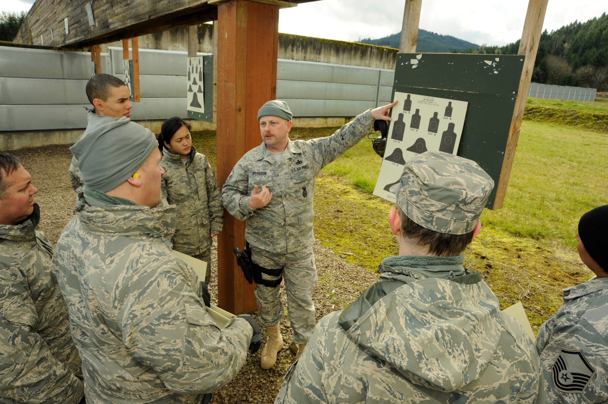 Oregon Air National Guard Master Sgt. Paul Persson 116th ACS Security Forces, describes in detail, the firing targets that all of the Airmen of the 116th Air Control Squadron need to achieve as part of their weapons qualifying at Camp Adair, Ore., on February 17, 2011. Over 80 Airmen of the 116th ACS will deploy in March of 2010 to the Middle East in support of Operation Enduring Freedom. (U.S. Air Force photograph by Tech. Sgt. John Hughel, 142nd Fighter Wing Public Affairs)