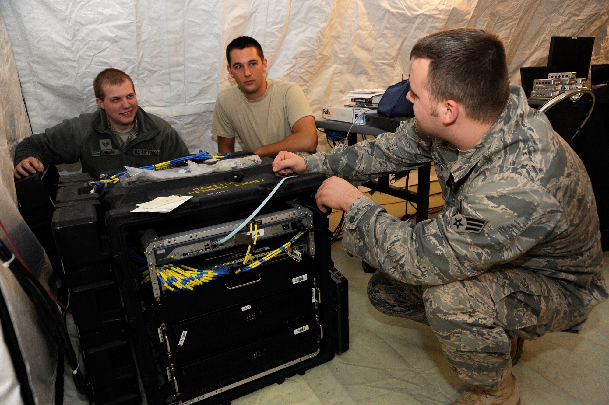 Oregon Air National Guard Airmen, Staff Sgt. (left to right) Tyler Birman, Staff Sgt. Nathanael Pfund and Senior Airman Matthew Martin of the 116th Air Control Squadron, based at Camp Rilea, Ore., review some of the maintenance procedures they will have to preform on their upcoming deployment on February 3, 2011. The 116th ACS will deploy over 80 Airmen in March of 2011 to the Middle East to support Operation Enduring Freedom. (U.S. Air Force photograph by Tech. Sgt. John Hughel, 142nd Fighter Wing Public Affairs)