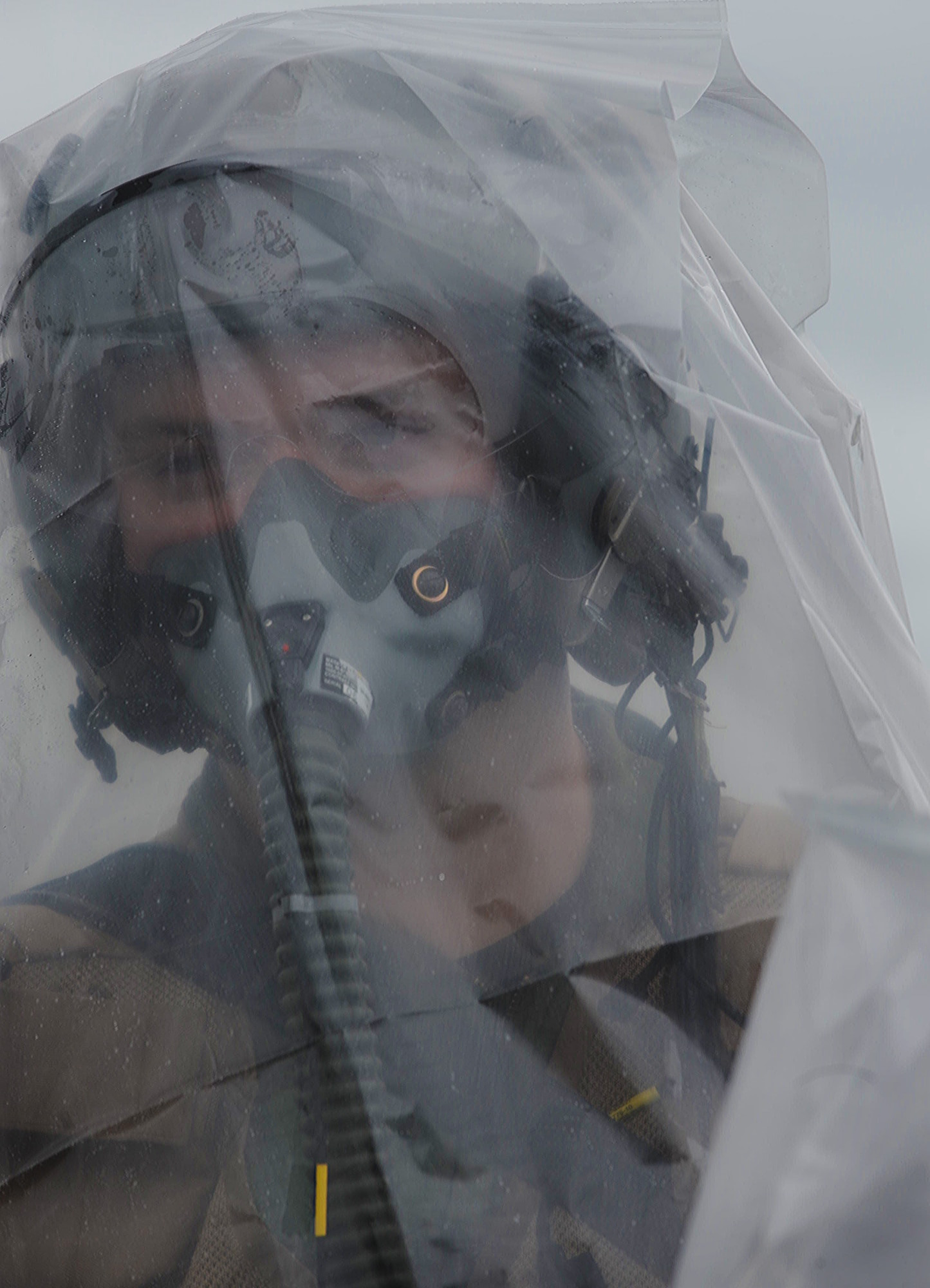 An Airmen plays a simulated contaminated member of an aircrew awaiting decontamination at Base Y on Joint Base Pearl Harbor-Hickam, Hawaii during the Operational Exercise March 5. The ORE tested Airmen's ability to respond to survive and operate during various wartime conditions. (U.S. Air Force photo/Airman1st Class Lauren Main)