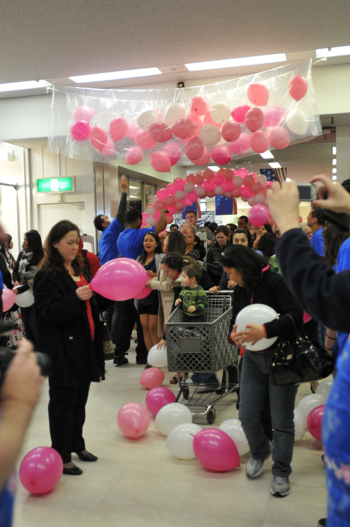 YOKOTA AIR BASE, Japan – Exchange customers retrieve balloons containing coupons during the grand re-opening ceremony here March 4. Giveaways, discounts and other activities were held in celebration of the newly renovated facility. (U.S. Air Force photo/Airman 1st Class Krystal M. Garrett)
