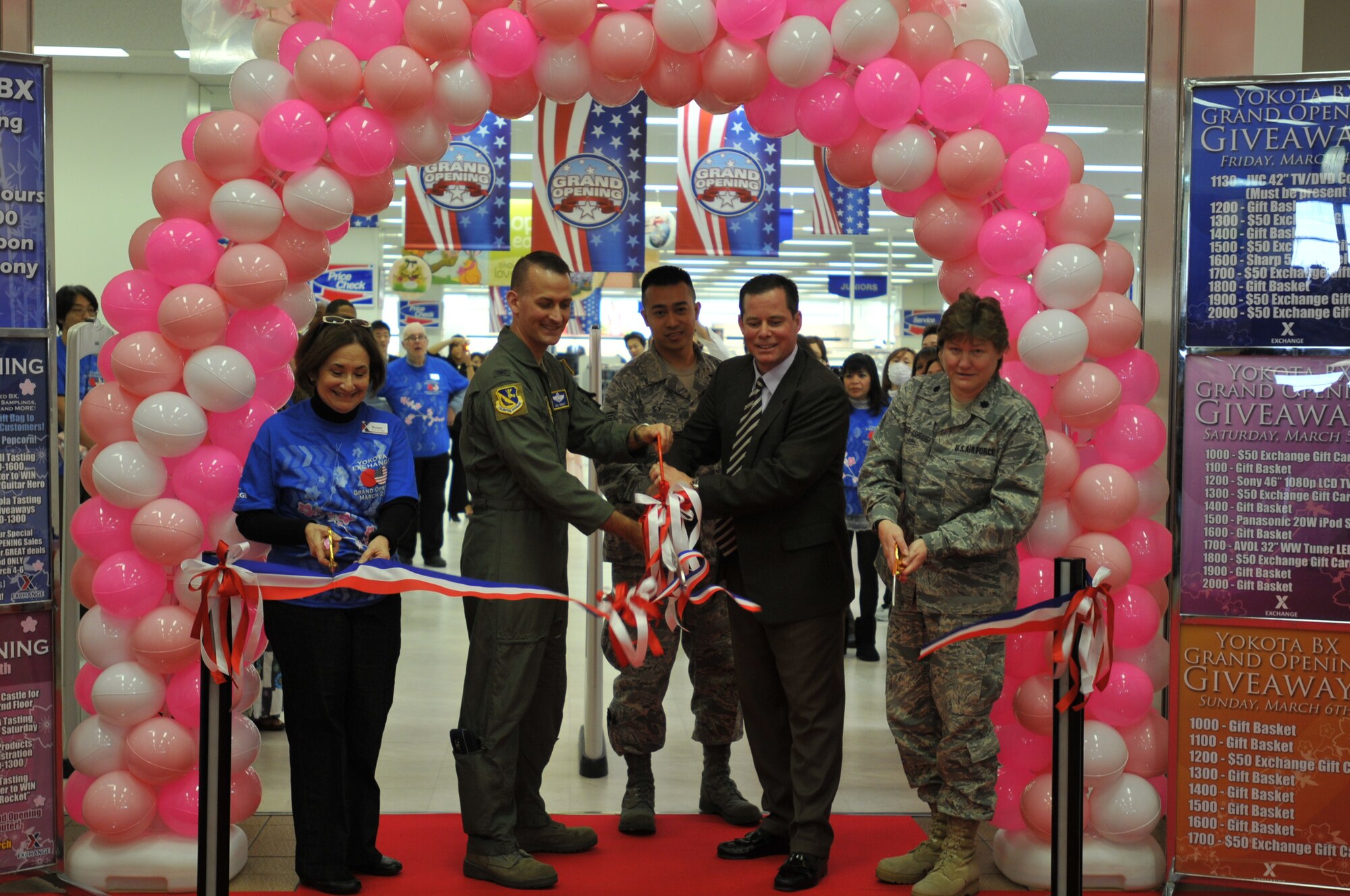 YOKOTA AIR BASE, Japan -- (Left to right) Rosi Womack, Exchange store manager, Col. Bill Knight, 374th Airlift Wing vice commander, George Ricker, Exchange general manager, and Lt. Col. Julie Plummer-Ashbaugh, 374th Mission Support Group deputy commander, participate in the ribbon cutting ceremony during the grand re-opening of the Yokota Exchange here March 4. (U.S. Air Force photo/Airman 1st Class Krystal M. Garrett)