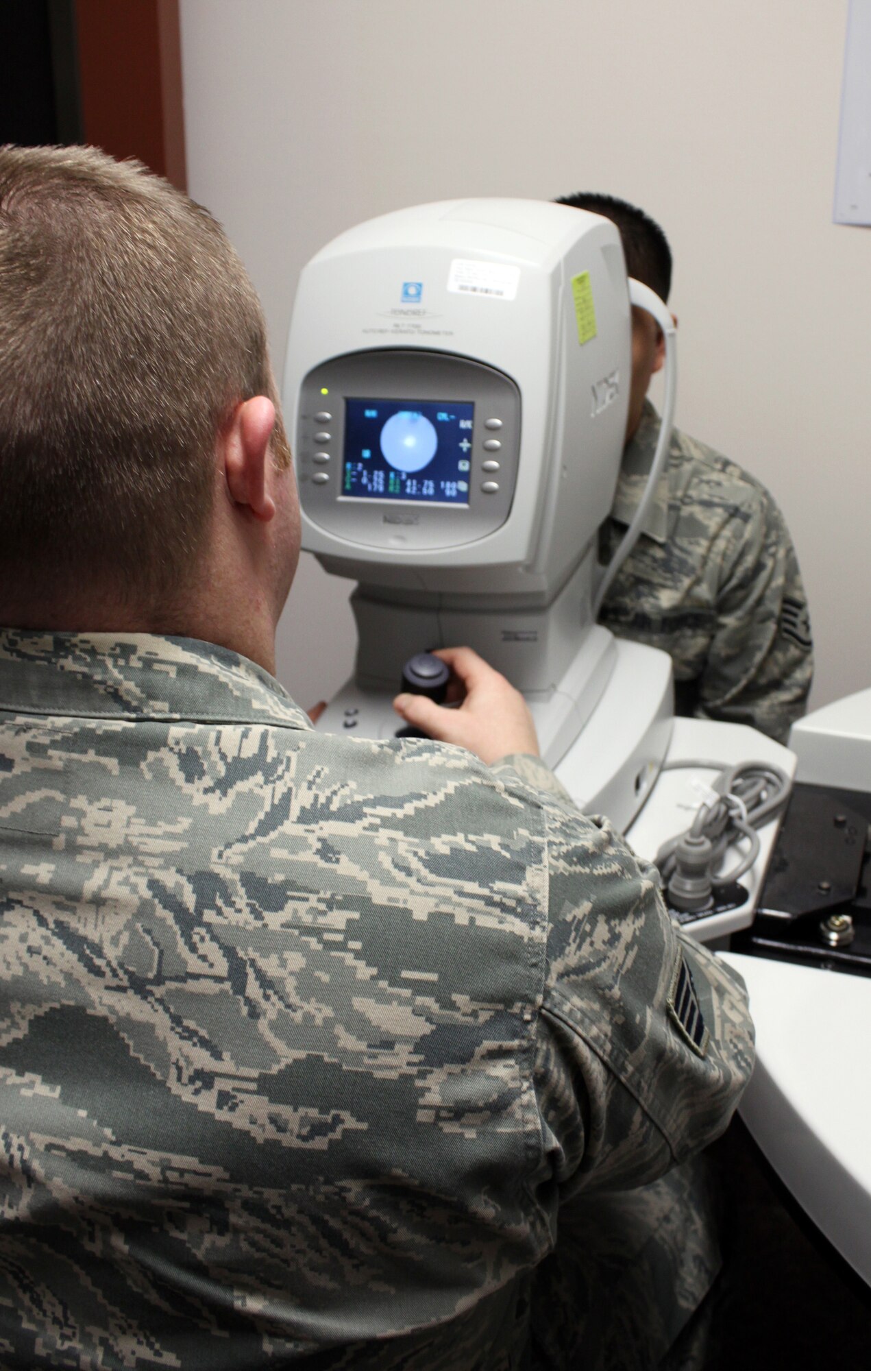 Staff Sgt. Scott Drake takes readings from an auto refractor March 3, 2011 Eielson Air Force Base, Alaska. The refractor gives the optometrist a rough estimate on what should be a patient’s prescription. Sergeant Drake is an optometry technician assigned to the 354th Medical Group. (U.S. Air Force Photo/Jessica Carr)