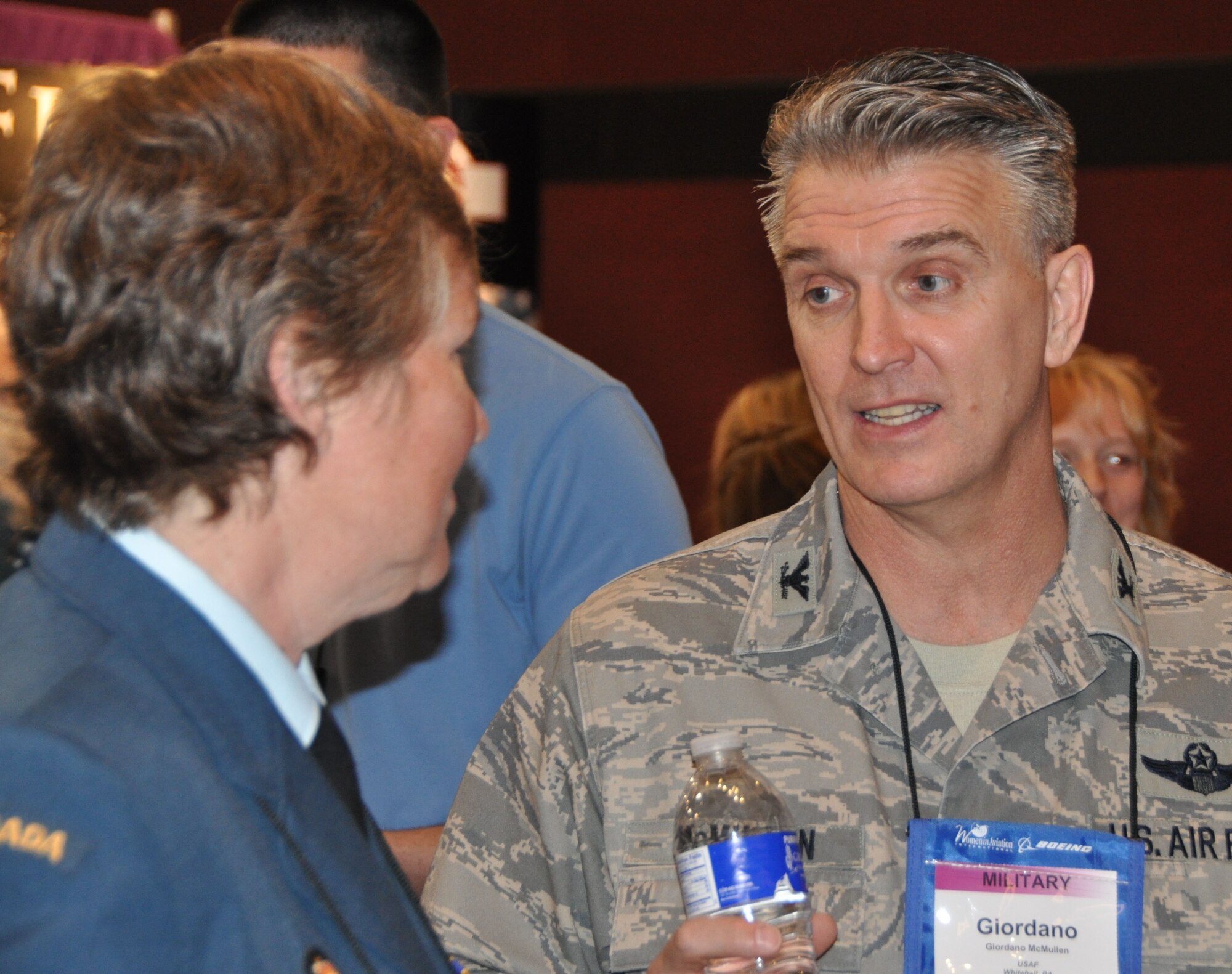 RENO, NV - Col. Giordano McMullen, commander, 514th Air Mobility Wing talks with a female pilot from a Canadian airlines during the 22nd Annual Women in Aviation International Conference held Feb. 24-26 in Reno, Nev. (U.S. Air Force photo/Master Sgt. Donna T. Jeffries)