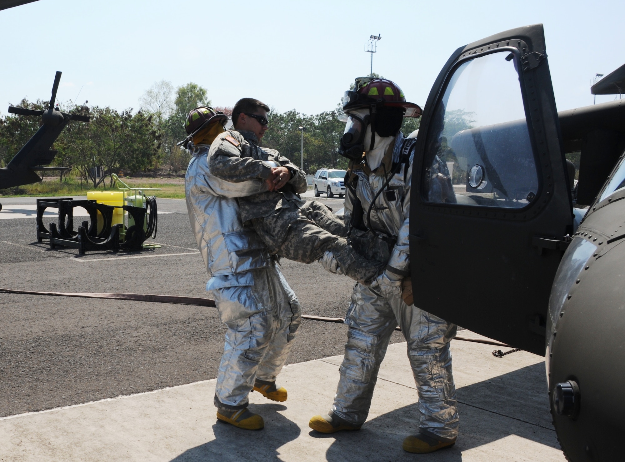 SOTO CANO AIR BASE, Honduras - Firefighters from the 612th Air Base Squadron “rescue” an aircrew member from an “inflamed" UH-60 during a no-notice exercise here, March 8. U.S. forces at Soto Cano Air Base train to ensure the highest levels of proficiency and readiness are maintained, guaranteeing preparation for any mission, emergency or crisis throughout the region. (U.S. Air Force photo/Staff Sgt. Kimberly Rae Moore)
