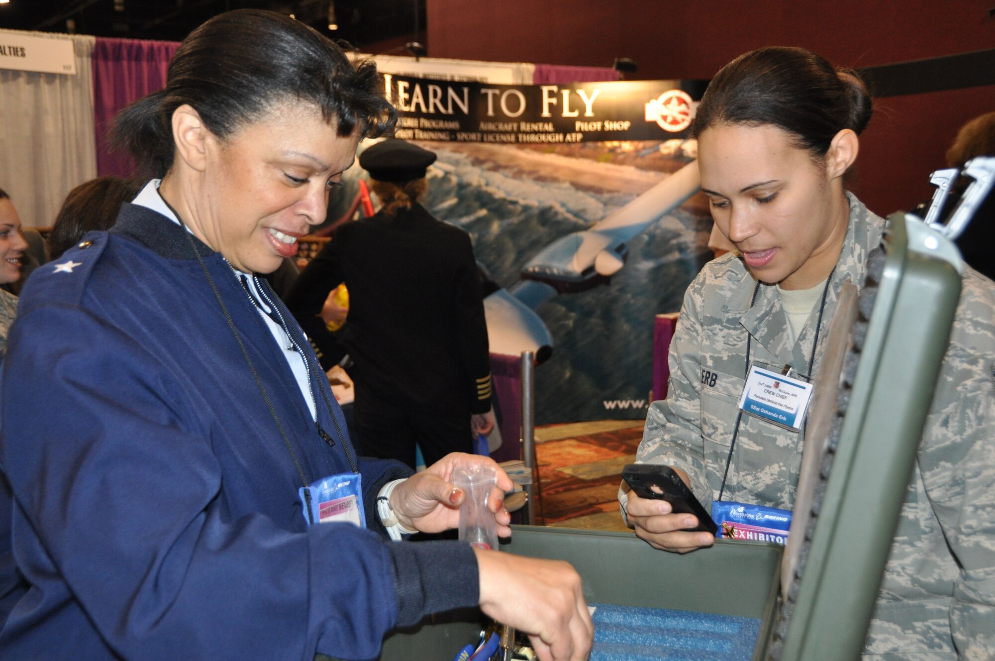 RENO, NV - Staff Sgt. Oshanda Erb, an Air Force Reserve KC-10 Extender crew chief, times Brig. Gen. Stayce D. Harris of the U.S. Africa Command and United Airlines Captain, while she completes a tool skill test at the 22nd Annual Women in Aviation International Conference held Feb 24-26 in Reno, NV. (U.S. Air Force photo/Master Sgt. Donna T. Jeffries)