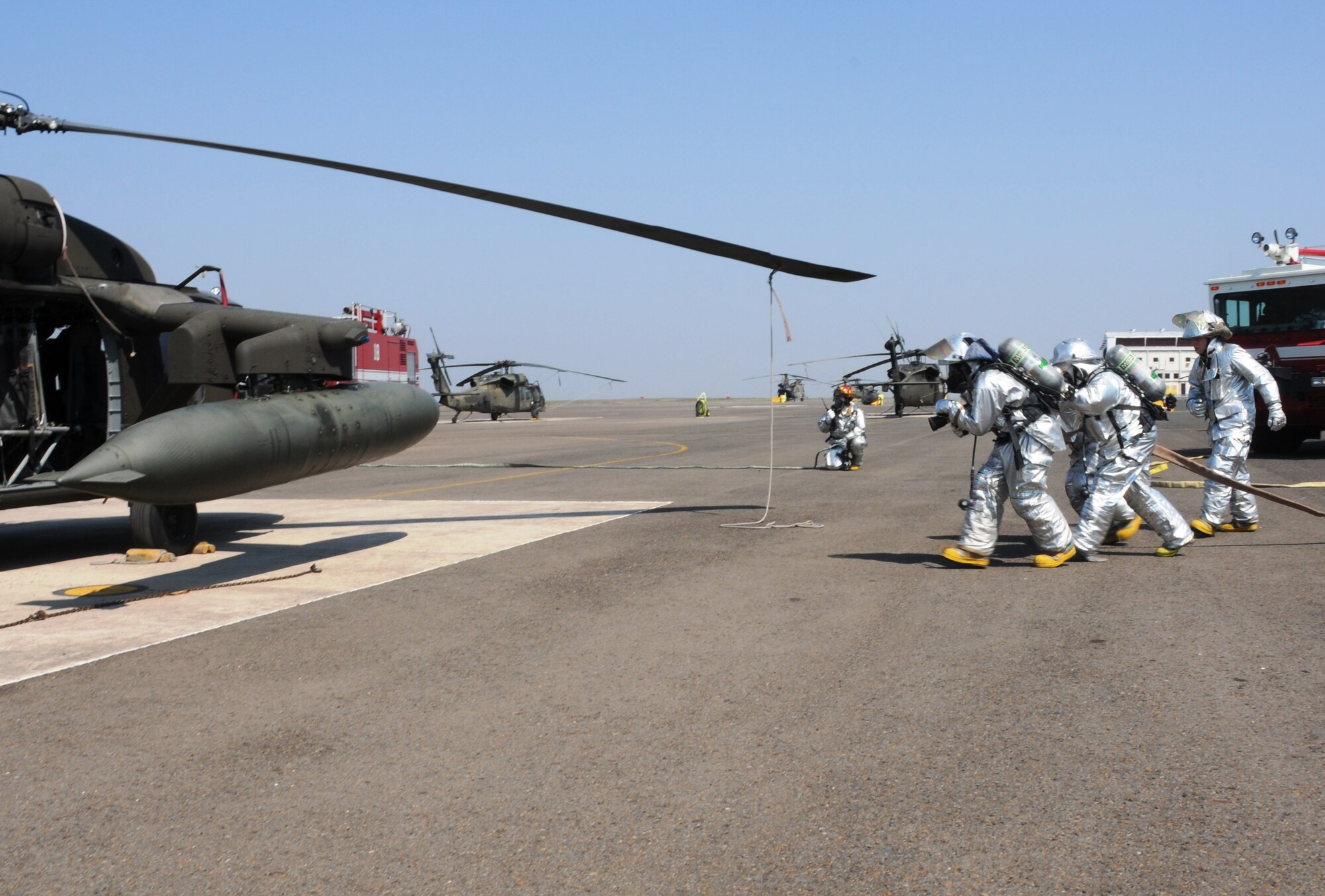 SOTO CANO AIR BASE, Honduras - Firefighters from the 612th Air Base Squadron approach an “inflamed" UH-60 during a no-notice exercise here, March 8. U.S. forces at Soto Cano Air Base train to ensure the highest levels of proficiency and readiness are maintained, guaranteeing preparation for any mission, emergency or crisis throughout the region. (U.S. Air Force photo/Staff Sgt. Kimberly Rae Moore)
