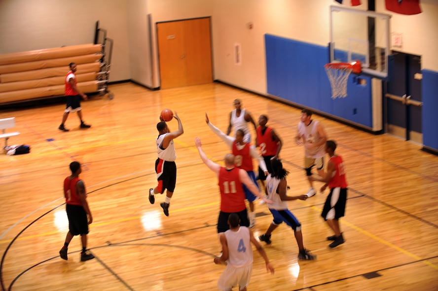 MOODY AIR FORCE BASE, Ga. -- Timothy Calhoun, 23rd Force Support Squadron team member, makes a pass to Blake Williams during the championship intramural basketball game March 7. The 23rd FSS played smart by looking for an open teammate throughout the game which led to a win with a score of 68-61. (U.S. Air Force photo/Airman 1st Class Douglas Ellis)(RELEASED)
