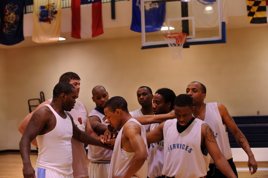 MOODY AIR FORCE BASE, Ga. -- Team members from the 23rd Force Support Squadron form a huddle during a time out to discuss a way to keep the 822nd Base Defense Squadron from scoring during the championship intramural basketball game March 7. After trailing by as much as 12 points, the 23rd FSS regrouped and ended up leading at the end of the first half with a score of 34-31. (U.S. Air Force photo/Airman 1st Class Douglas Ellis)(RELEASED)
