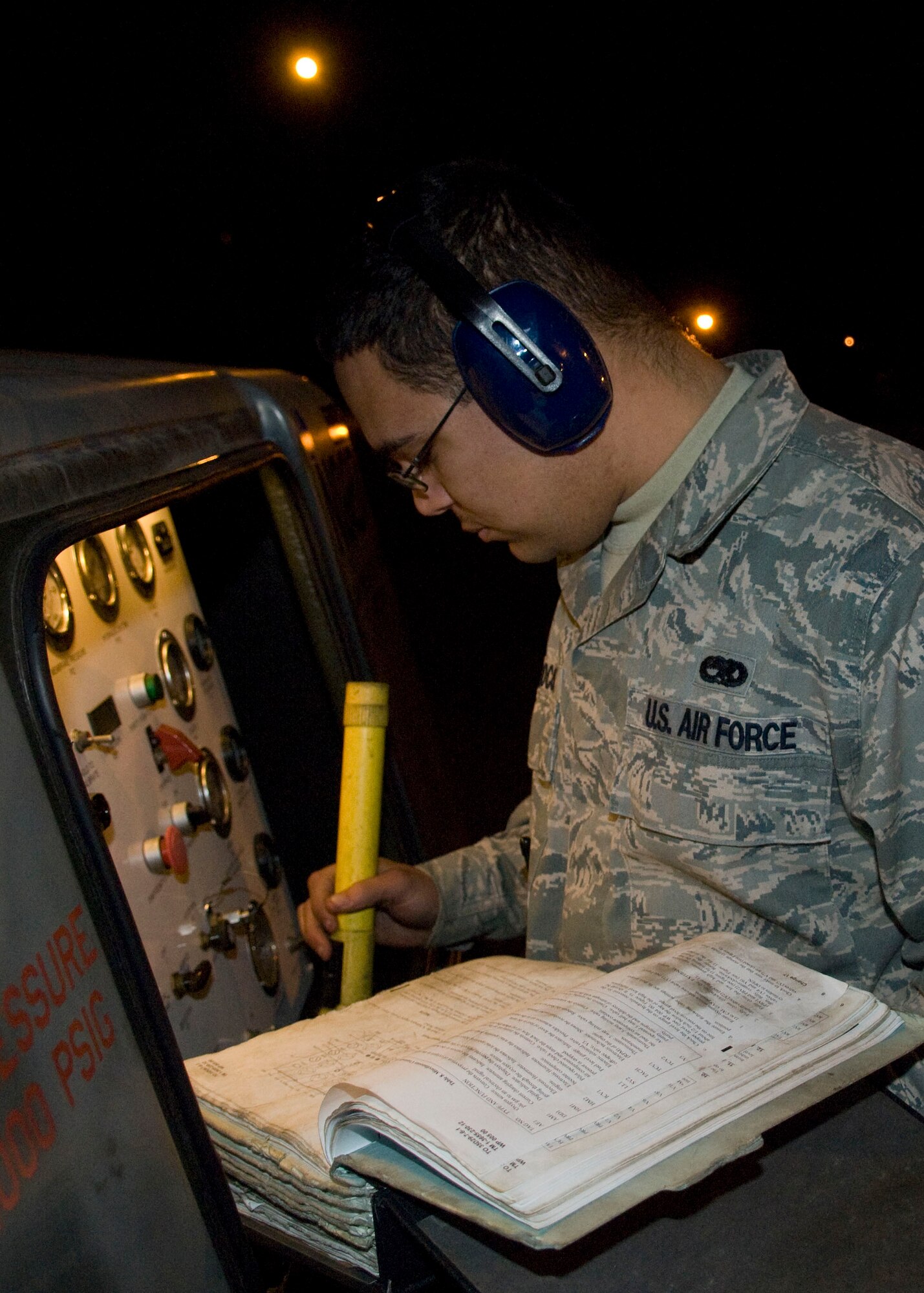 YOKOTA AIR BASE, Japan -- Senior Airman Eric Woodcox, 374th Maintenance Squadron aerospace ground equipment journeyman, reviews a technical order for pre-operational checks on a self-generating nitrogen cart during an Operational Readiness Exercise here March 8. These inspections help ensure operational serviceability of equipment used to maintain aircraft. (U.S. Air Force photo/Airman 1st Class Andrea Salazar)