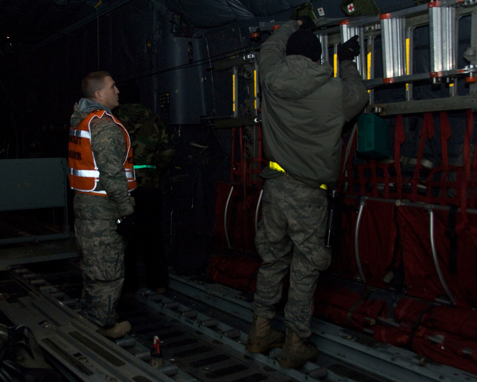 YOKOTA AIR BASE, Japan -- Master Sgt. Scott Ford, 374th Aircraft Maintenance Squadron aircraft manager, and Staff Sgt. Jason Mullick, 374th AMXS crewchief, perform pre-flight servicing aboard a C-130 Hercules during an Operational Readiness Exercise here March 7. Pre-flight servicing ensures that the overall functions of the aircraft operate properly before take-off, which also ensures the safety of aircrew members on-board. (U.S. Air Force photo/Airman 1st Class Andrea Salazar)