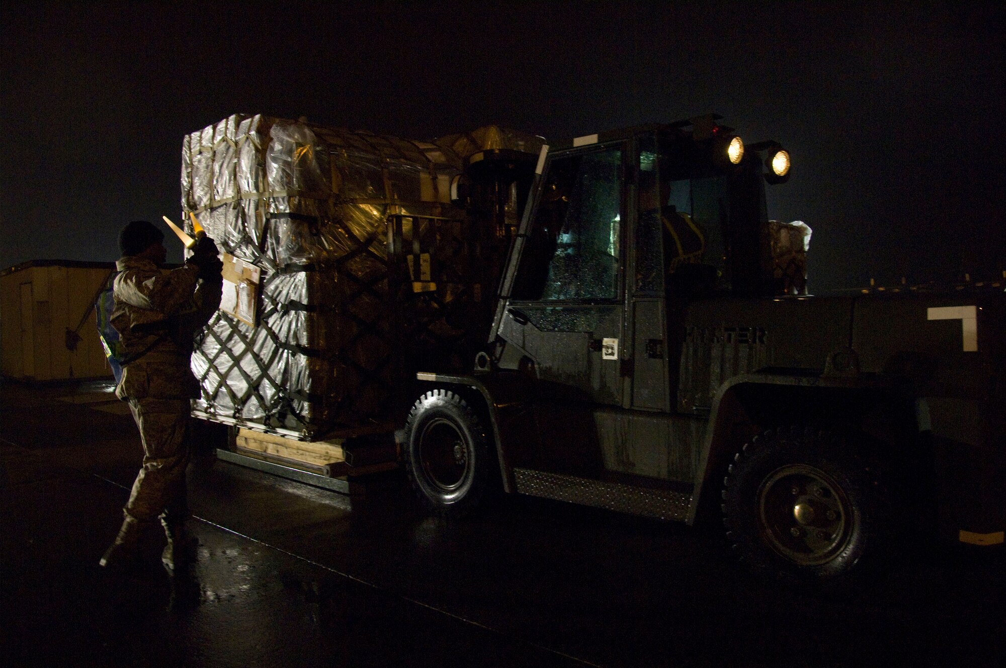 YOKOTA AIR BASE, Japan -- Airman 1st Class Jarrett Hunt, 374th Maintenance Squadron aerospace propulsion apprentice, guides a forklift carrying a medical cargo pallet during an Operational Readiness Exercise here March 7. Airmen from the 374th MXS moved multiple pallets of essential cargo to ensure mission readiness. (U.S. Air Force photo/Airman 1st Class Andrea Salazar) 