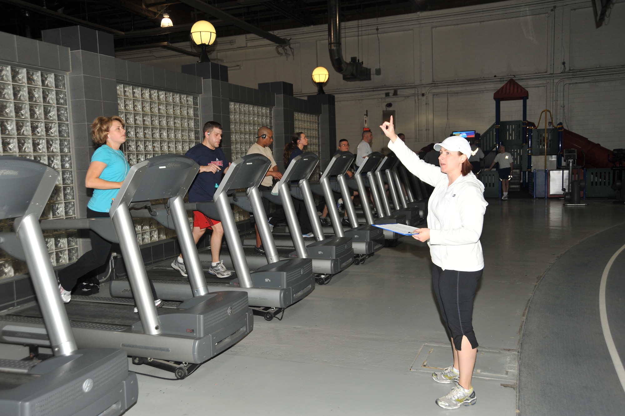 OFFUTT AIR FORCE BASE, Neb. - Marcy Jameson, HAWC Flight Chief & Exercise Physiologist, gestures to participants in the Get Fit Run class at the Offutt Field House.  Mrs. Jameson leads the class every Friday at 6:30 a.m. U.S. Air Force photo by D.P. Heard