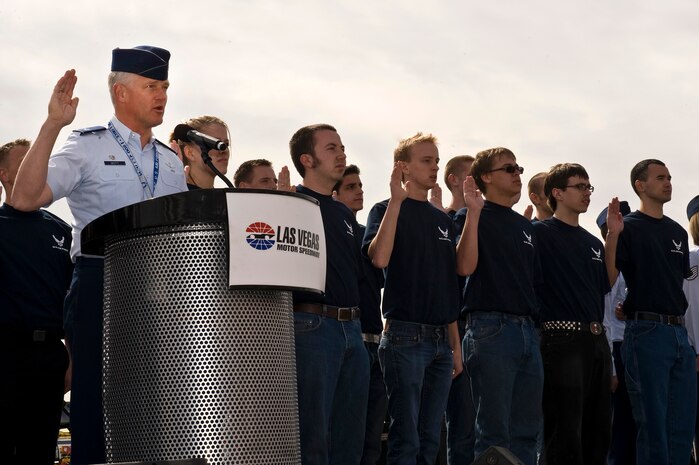 LAS VEGAS -- Col. William Mott, 37th Training Wing commander, Lackland Air Force Base, Texas, administers the Oath of Enlistment to U.S. Air Force recruits during the Kobalt Tools 400 race at the Las Vegas Motor Speedway as part of the NASCAR Sprint Cup Series March 6.For more than a decade, Nellis Air Force Base Airmen have volunteered at the Las Vegas Motor Speedway. (U.S. Air Force photo by Senior Airman Brett Clashman)