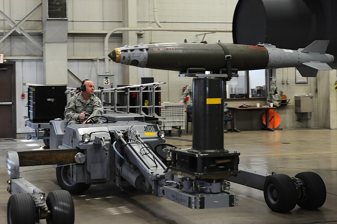 Tech. Sgt. Steven Rothmund, 37th Bomb Squadron weapons load crew team chief, transports a mock guided bomb unit 38 to a B-1B Lancer mock trainer during a local load crew competition at Ellsworth Air Force Base, S.D., March 4, 2011. The crew is rated on efficiency, safety and the speed which they load munitions. (U.S. Air Force photo/Senior Airman Kasey Close)