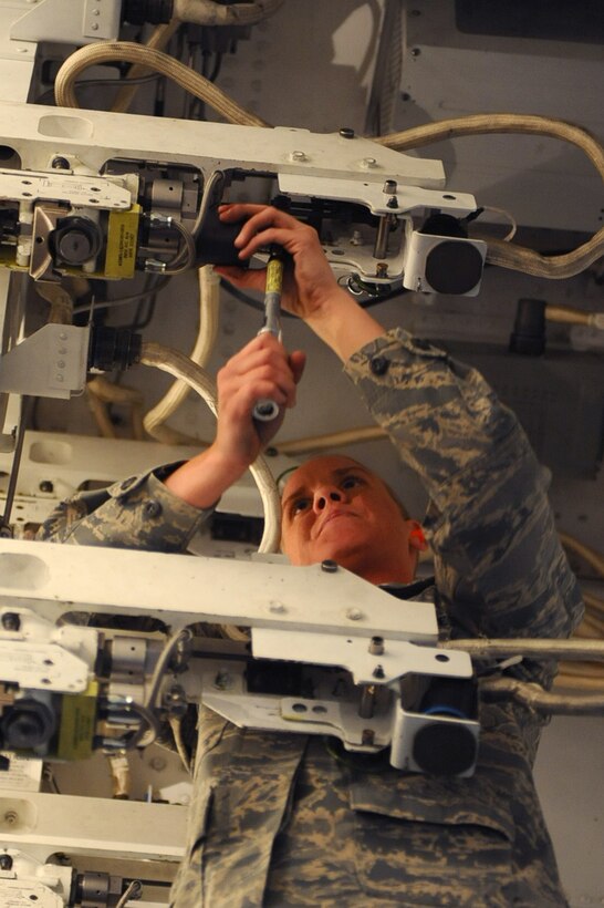 Senior Airman Brandy Will, 37th Bomb Squadron weapons load crew member, prepares a B-1B Lancer mock trainer to receive munitions during a local load crew competition at Ellsworth Air Force Base, S.D., March 4, 2011. The crew is rated on efficiency, safety and the speed which they load munitions. (U.S. Air Force photo/Senior Airman Kasey Close)