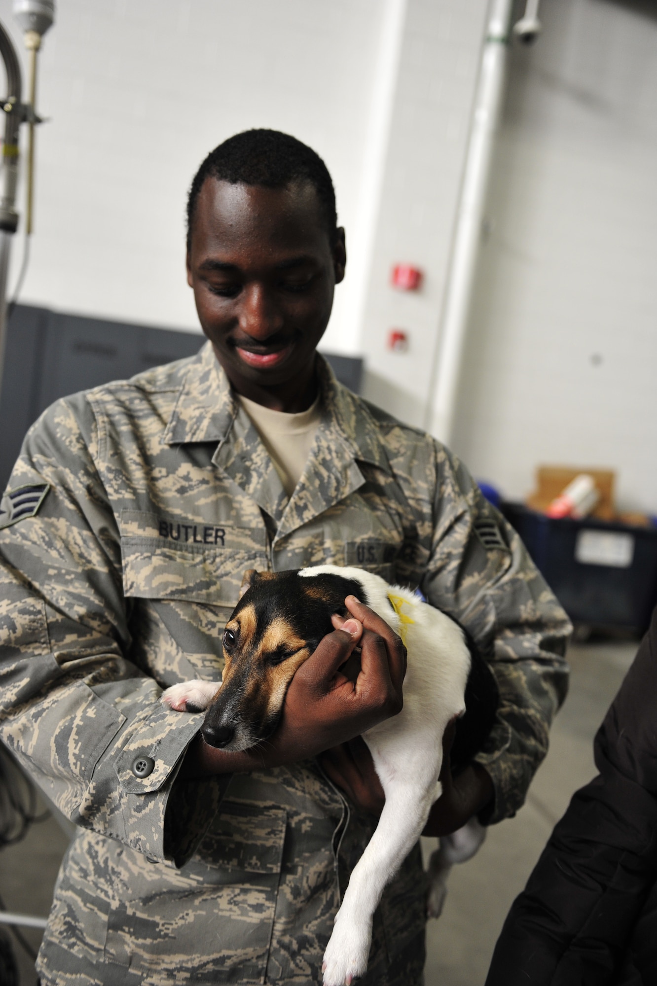 Senior Airman James Butler, 819th Global Support Squadron in-transit visibility manager, holds his Jack Russell Terrier, Jex, during the 621st Contingency Response Wing’s family open house at the Joint Base McGuire-Dix-Lakehurst, N.J. Global Reach Deployment Center here March 4.  The event included activities and food for the families alongside demonstrations of the specialized equipment used by the unit to provide emergency global mobility support to humanitarian crises and national defense operations. (U.S. Air Force photo/Tech. Sgt. Parker Gyokeres) (Released)
