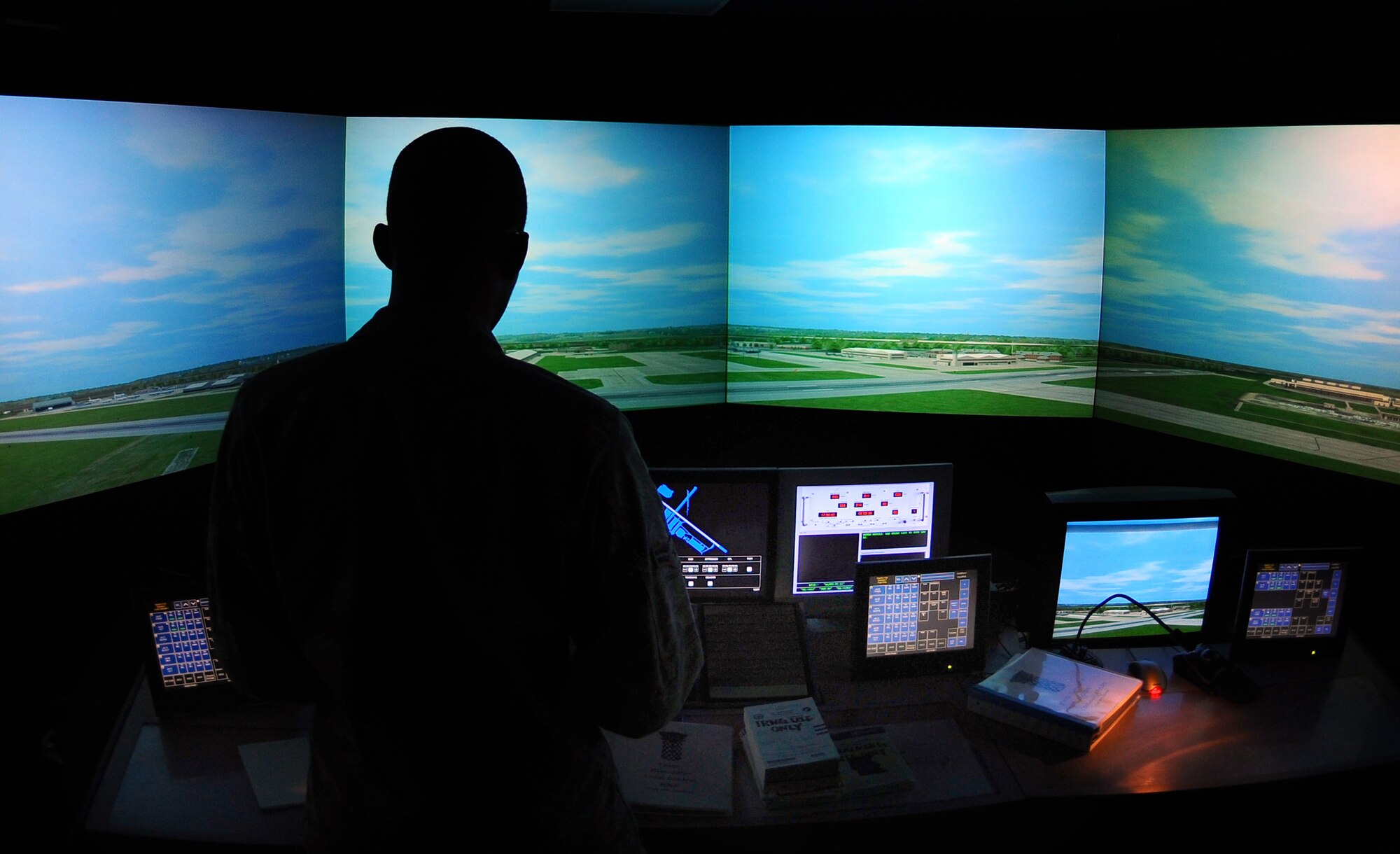 OFFUTT AIR FORCE BASE, Neb. - Airman 1st Class Derrick Miller, an air traffic controller apprentice assigned to the 55th Operations Support Squadron, spends time in an air traffic control simulator with a 180 degree monitor with a detailed view of Offutt as part of routine training here, Feb. 24. U.S. Air Force Photo by Josh Plueger (Released)
