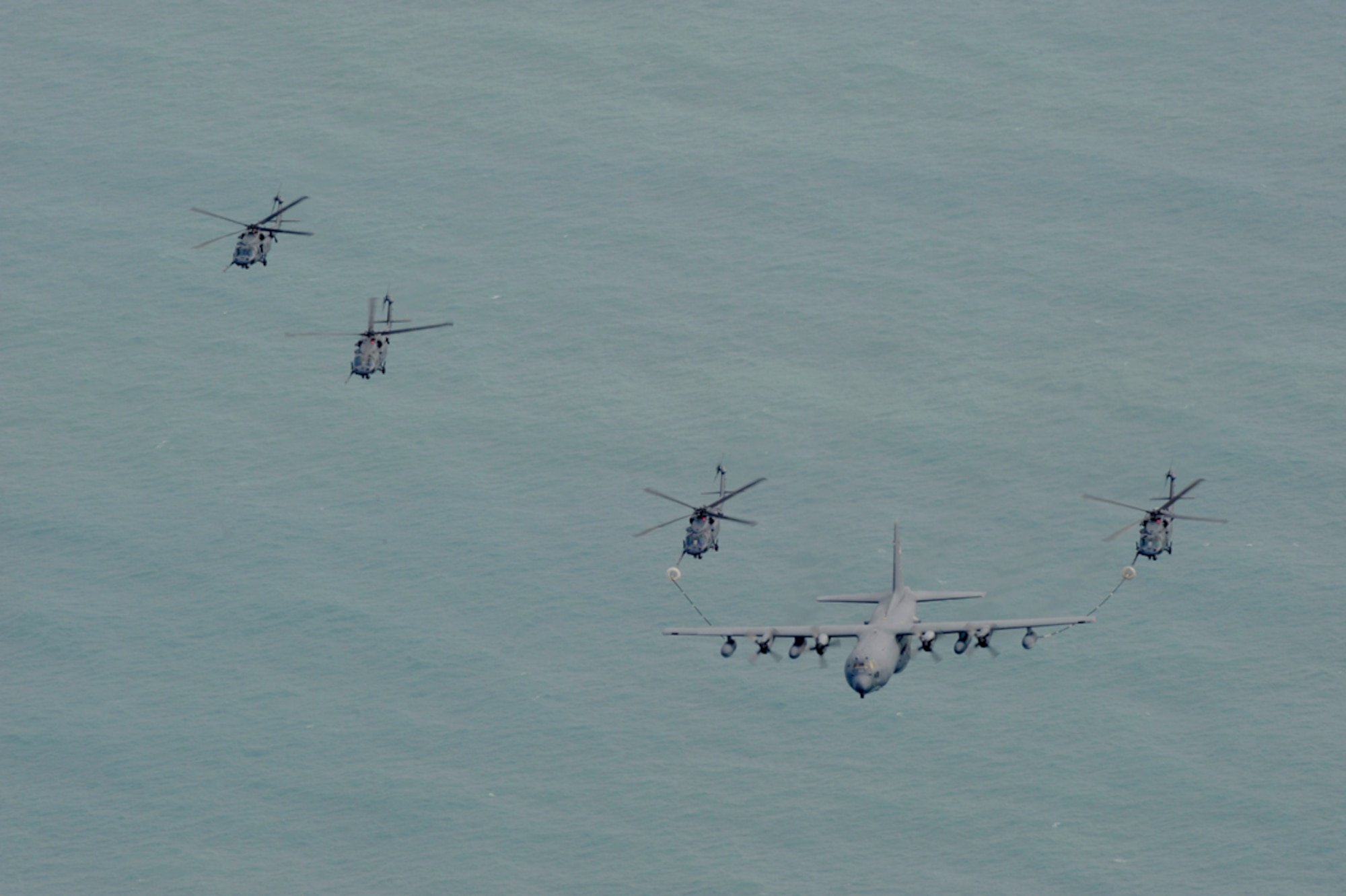 PATRICK AIR FORCE BASE, Fla. - Aircraft from the Air Force Reserve's 920th Rescue Wing here fly ovre the Atlantic Ocean after Airmen stepped up to the challenge from their commander, Col. Robert Dunn, who had them launch the wing's entire fleet March 6 during their drill training weekend. All together, Airmen launched six HH-60G Pave Hawk helicopters and three HC-130P/N King extended-range refueling aircraft. (U.S. Air Force photo/Master Sgt. Rob Grande)