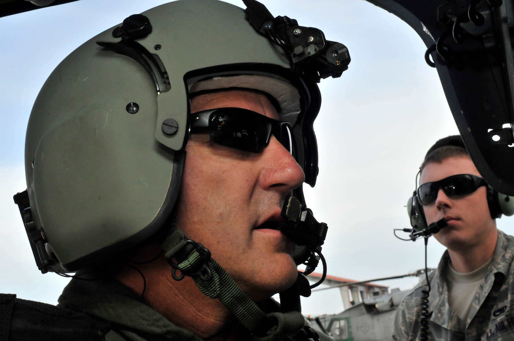 PATRICK AIR FORCE BASE, Fla. -  A maintenance Airmen from the Air Force Reserve's 920th Rescue Wing here works closely with an HH-60G Pave Hawk aviator prior to his crew taking flight. Wing Airmen stepped up to the challenge from their commander, Col. Robert Dunn, who had them launch the wing's entire fleet of aircraft March 6 during their drill training weekend to exercise their mass evacuation skills. (U.S. Air Force photo/Staff Sgt. Annamarie Wyant)