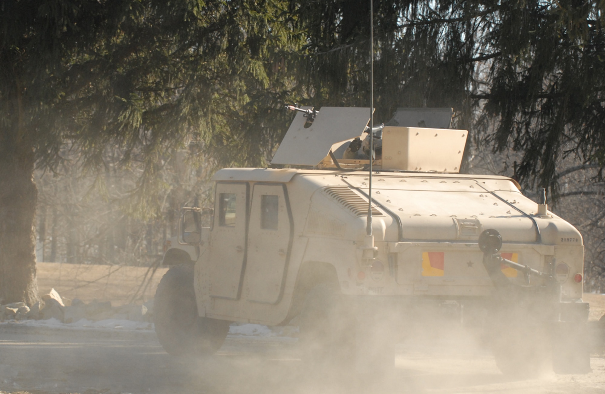 A convoy carrying soldiers and civilians moves out after a mock live-fire attack Feb. 10, 2011, at the 11-day Civilian Expeditionary Workforce predeployment training course at Muscatatuck Urban Training Center, Ind. The 11-day course equips civilians with the skills needed to successfully support combat and humanitarian missions in Afghanistan, Iraq and other locations around the world.  (Defense Department photo/Elaine Wilson)