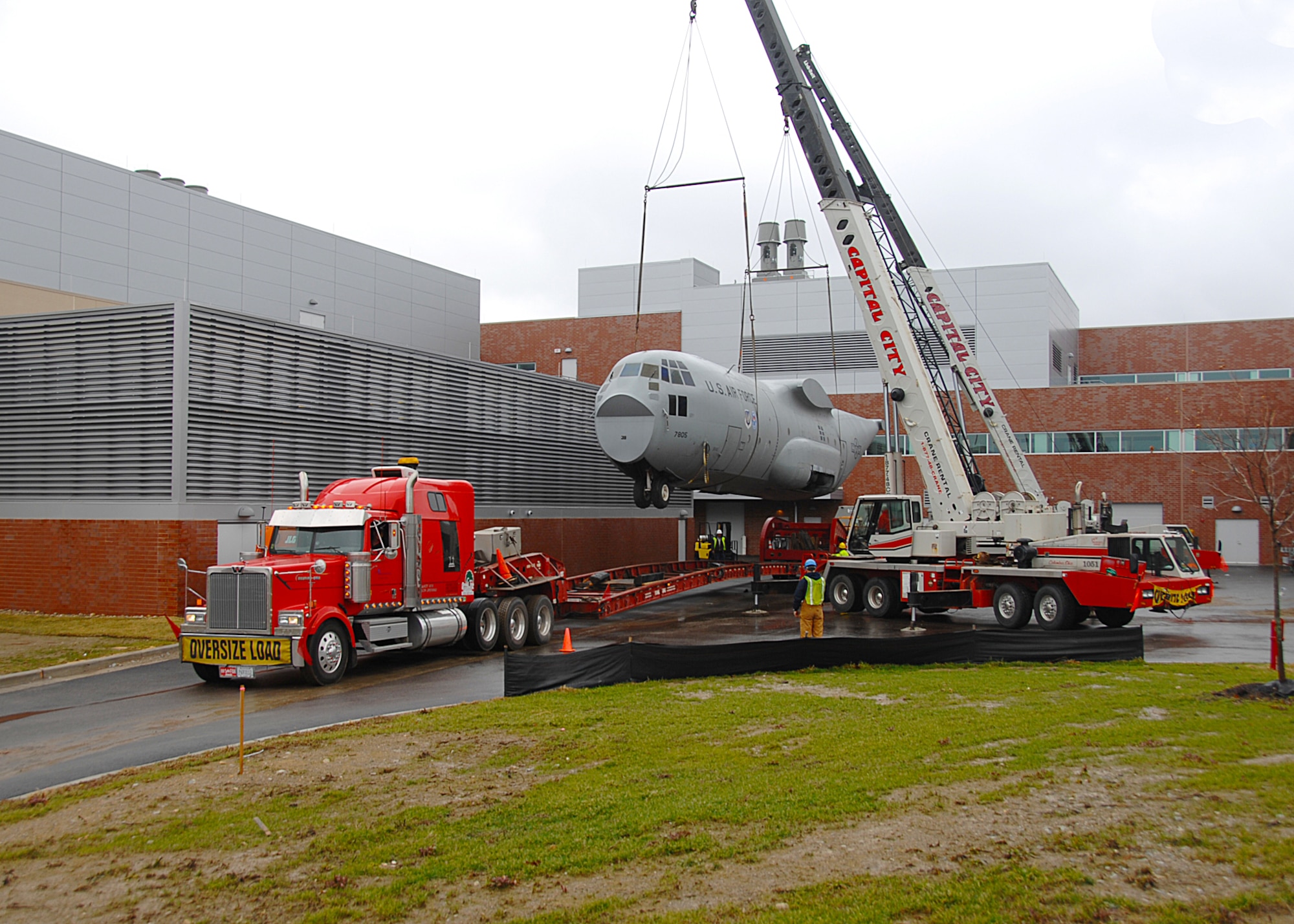 The C-130 Training Simulator is craned off the transportation trailer.
