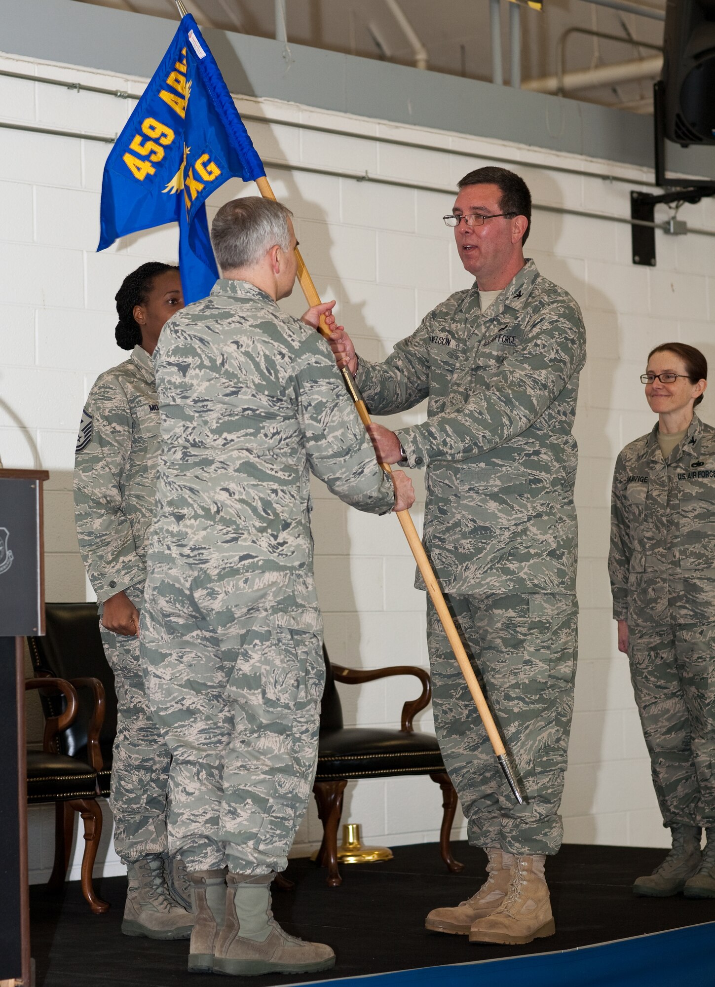 JOINT BASE ANDREWS, Md. -- Col. Timothy E. Nelson (right), passes the 459th Maintenance Group guidon to Col. James M. Allman, 459th Air Refueling Wing commander, during a change of command ceremony here Feb. 6. Col. Maureen G. Banavige (far right) now assumes command of the 459  MXG after serving previously as an Individual Mobilization Augmentee to the Chief, Logistics Operations Division, Directorate of Logistics, Air Mobility Command, Scott Air Force Base, Ill. (U.S. Air Force photo/Staff Sgt. John Meyer)