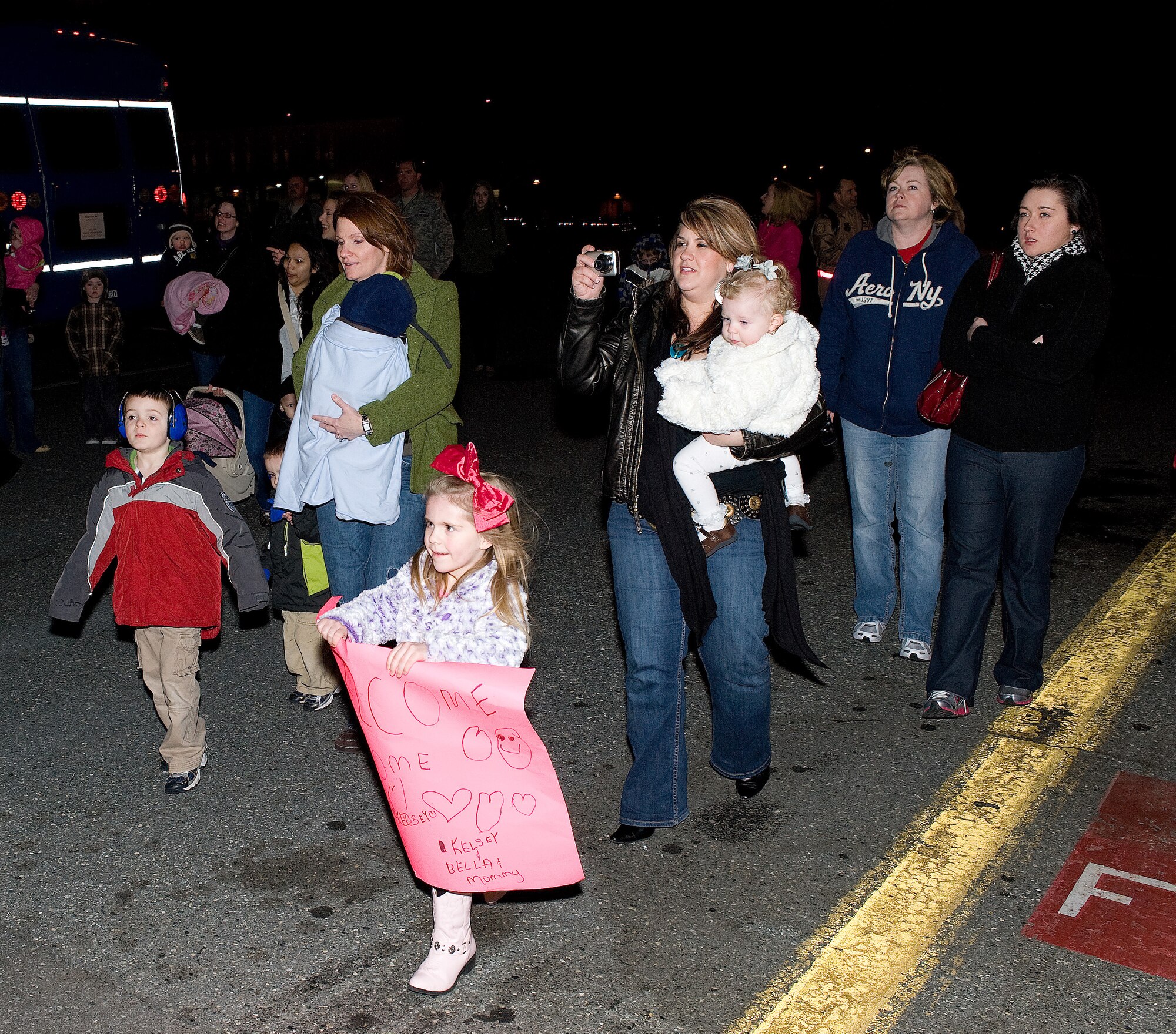 Family and friends rush to a C-5 as servicemembers exit the plane March 4, 2011 at Dover Air Force Base, Del. The servicemembers were deployed to Europe and the Middle East to support Operation Enduring Freedom. (U.S. Air Force photo by Jason Minto)