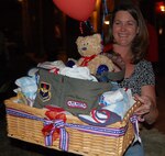 DEL RIO, Texas –Marianne Counsell, wife of Lt.Col. Jon Counsell, 47th Fighter Training Wing, displays one of many items that were being auctioned off for the second annual Laughlin Officers’ Spouses Club charitable auction held at the San Felipe Country Club.   The event raised more than$11,000 for individuals and families in need as well as organizations at Laughlin and in the Del Rio community. (U.S. Air Force Photo by Master Sgt. Peter Borys)
