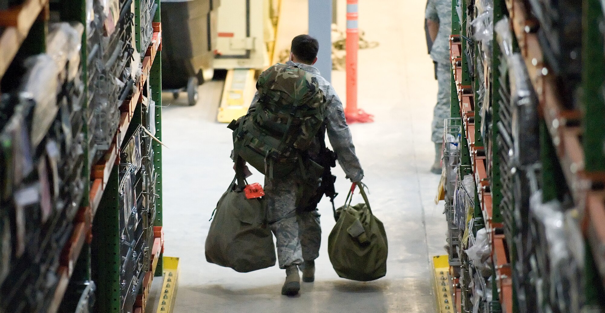 Staff Sgt. Christian Madrigal, 436th Security Forces Squadron, continues to the final checkpoint of the deployment processing line, March 3, 2011, at Dover Air Force Base. The deployment exercise is the first of many exercises scheduled for 2011 to prepare Team Dover for the Operational Readiness Inspection. (U.S. Air Force photo by Jason Minto)