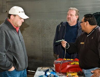 Randolph AFB, TX, 5 March 11: Paul Bergen (L) and Eddie Storey (R) discuss egress training and equipment with Rey Gutierrez from the egress shop while attending the Civilian Fly In at Randolph AFB on March 5, 2011  (U.S. Air Force photo/ By Don Lindsey)