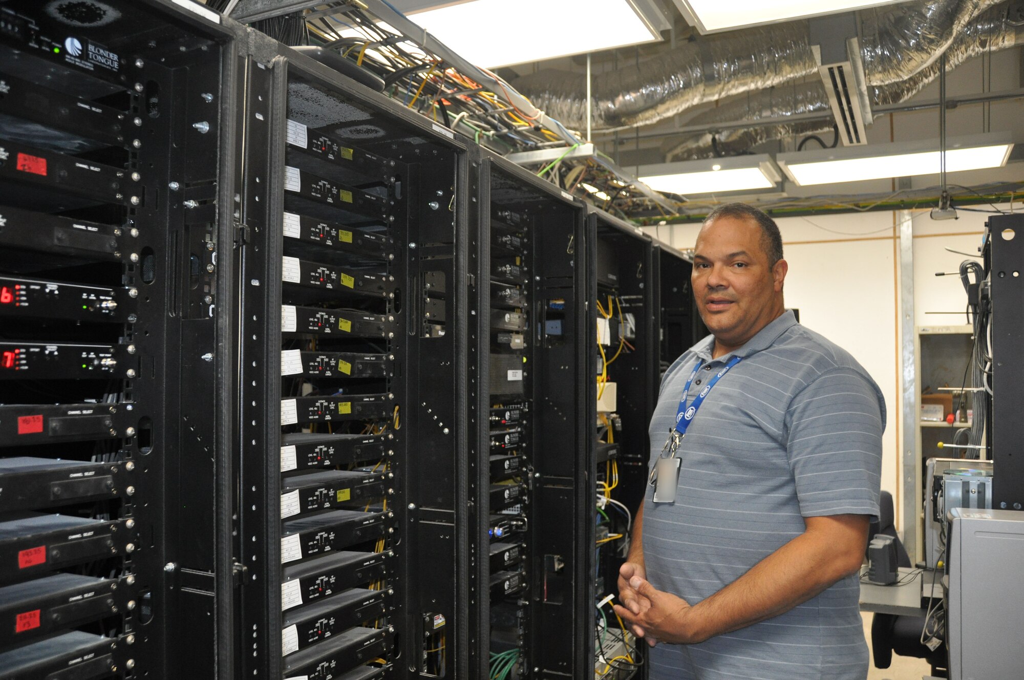 Tony Bonilla, 379th Expeditionary Communications Squadron cable television director, observes the ‘head end,’ a large room of equipment to include receivers, modulators and combiners.  From here the signals disperse to the base.  (U.S. Air Force photo/Senior Airman Veronica McMahon)